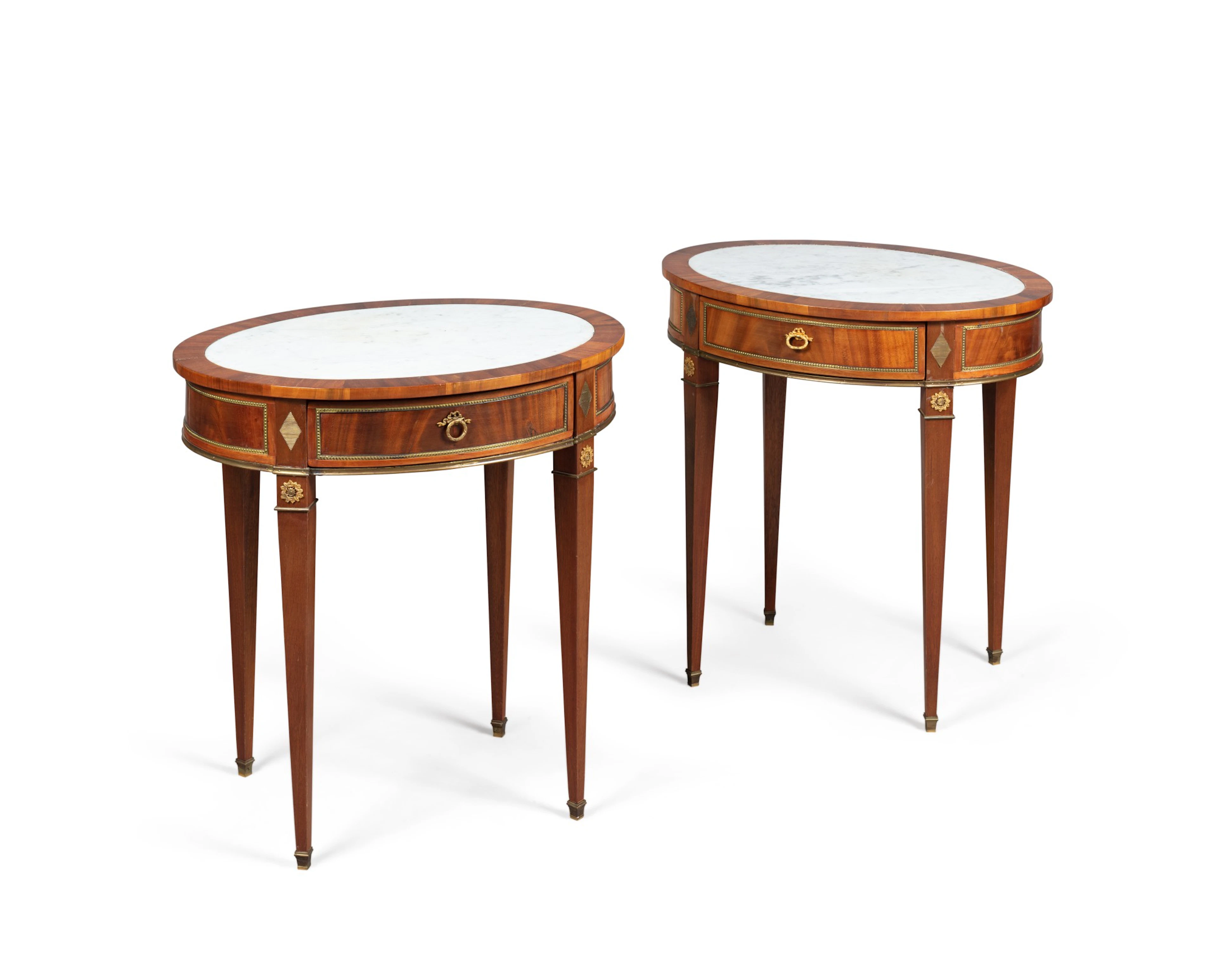A pair of mahogany neoclassical gilt brass mounted oval side tables