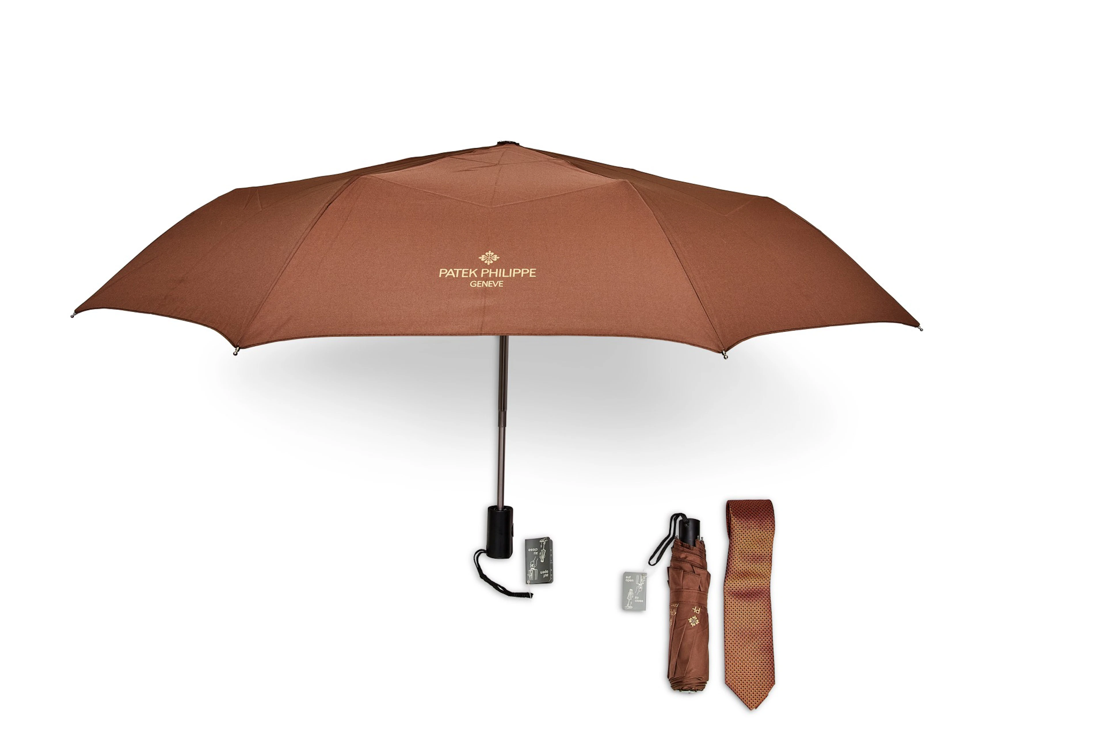 A set of two folding umbrellas and silk tie
