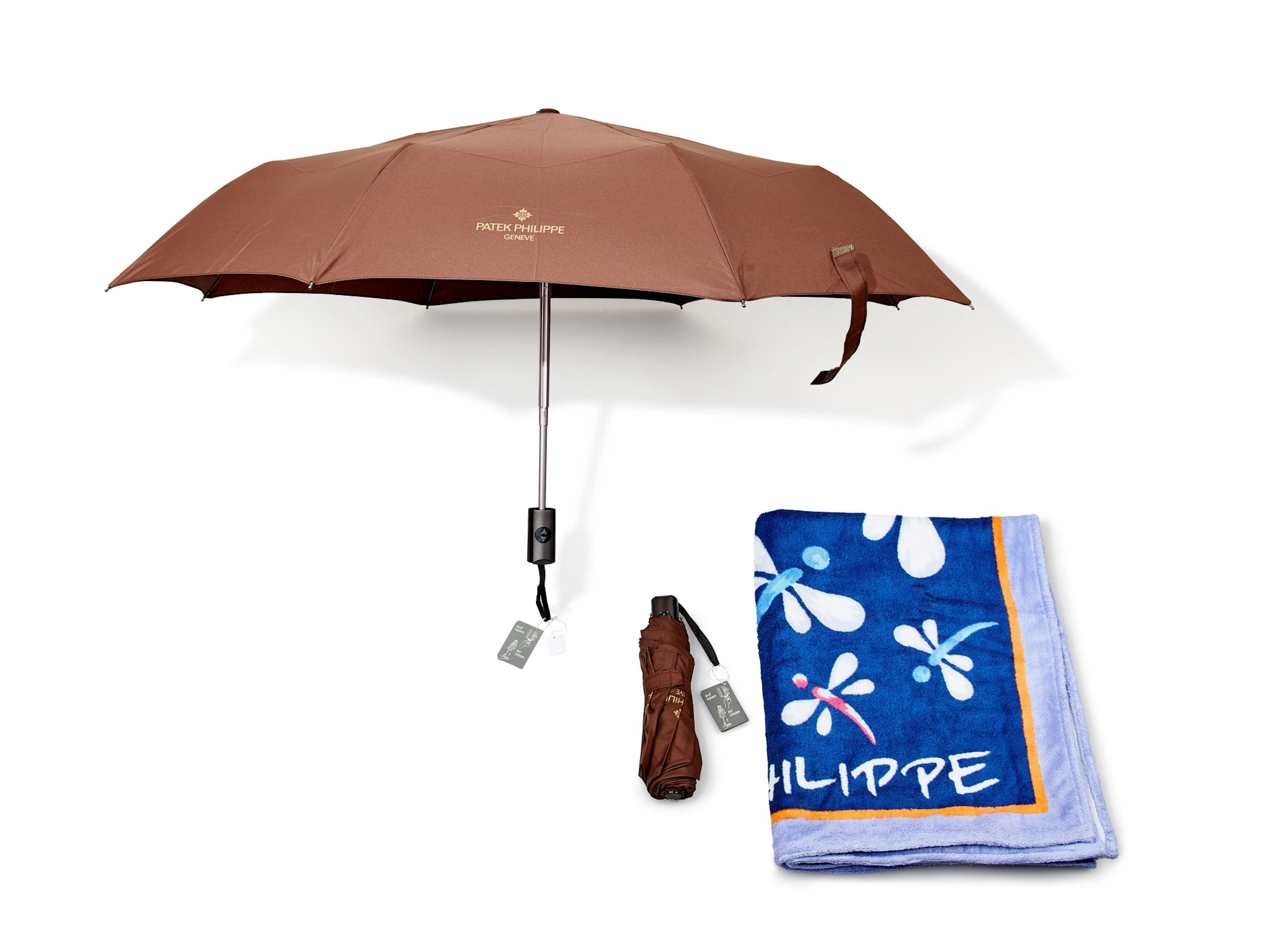 A set of two folding umbrellas and terry cloth blanket