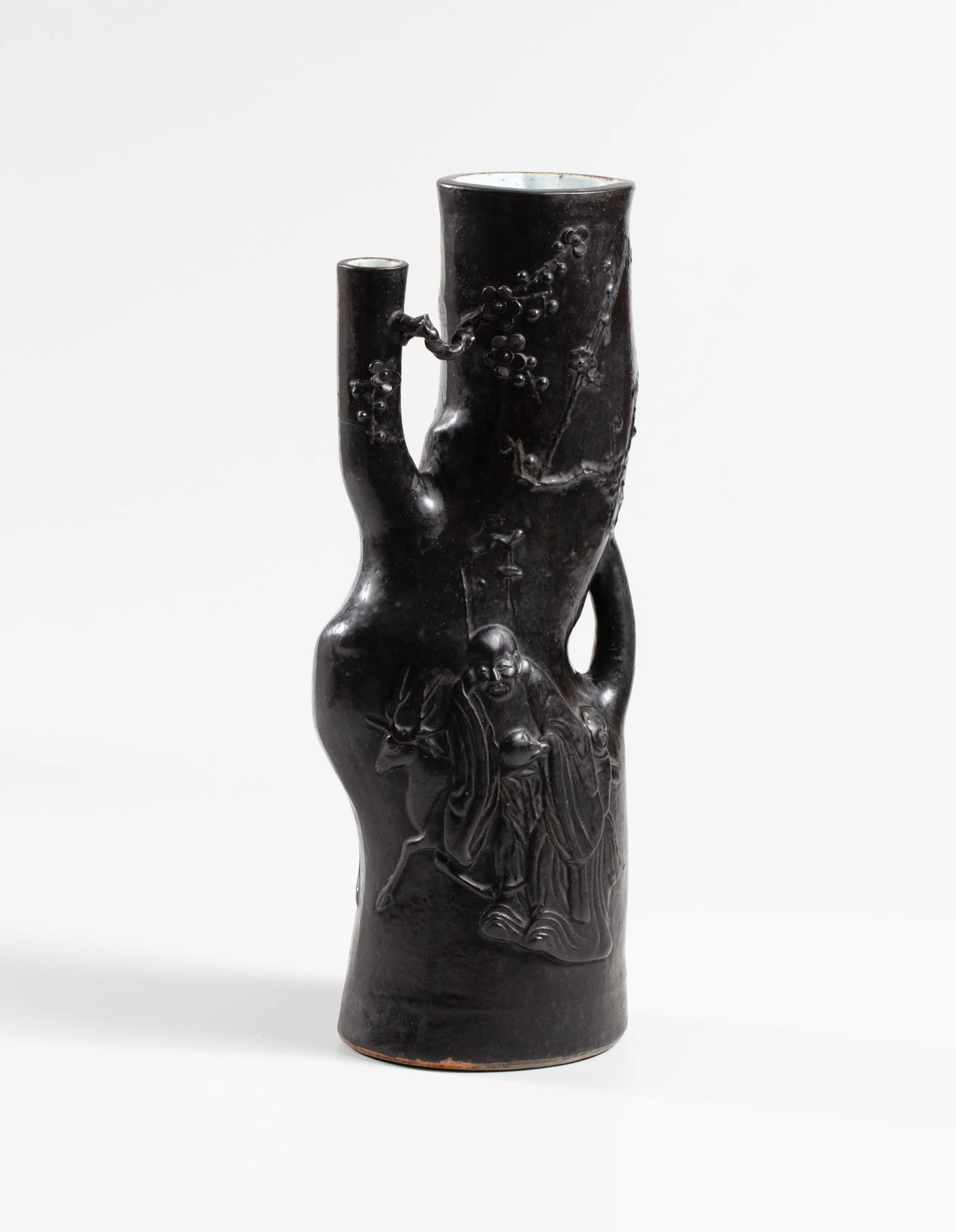 A large black-glazed tree trunk-shaped ‘Shoulao and deer’ moulded vase