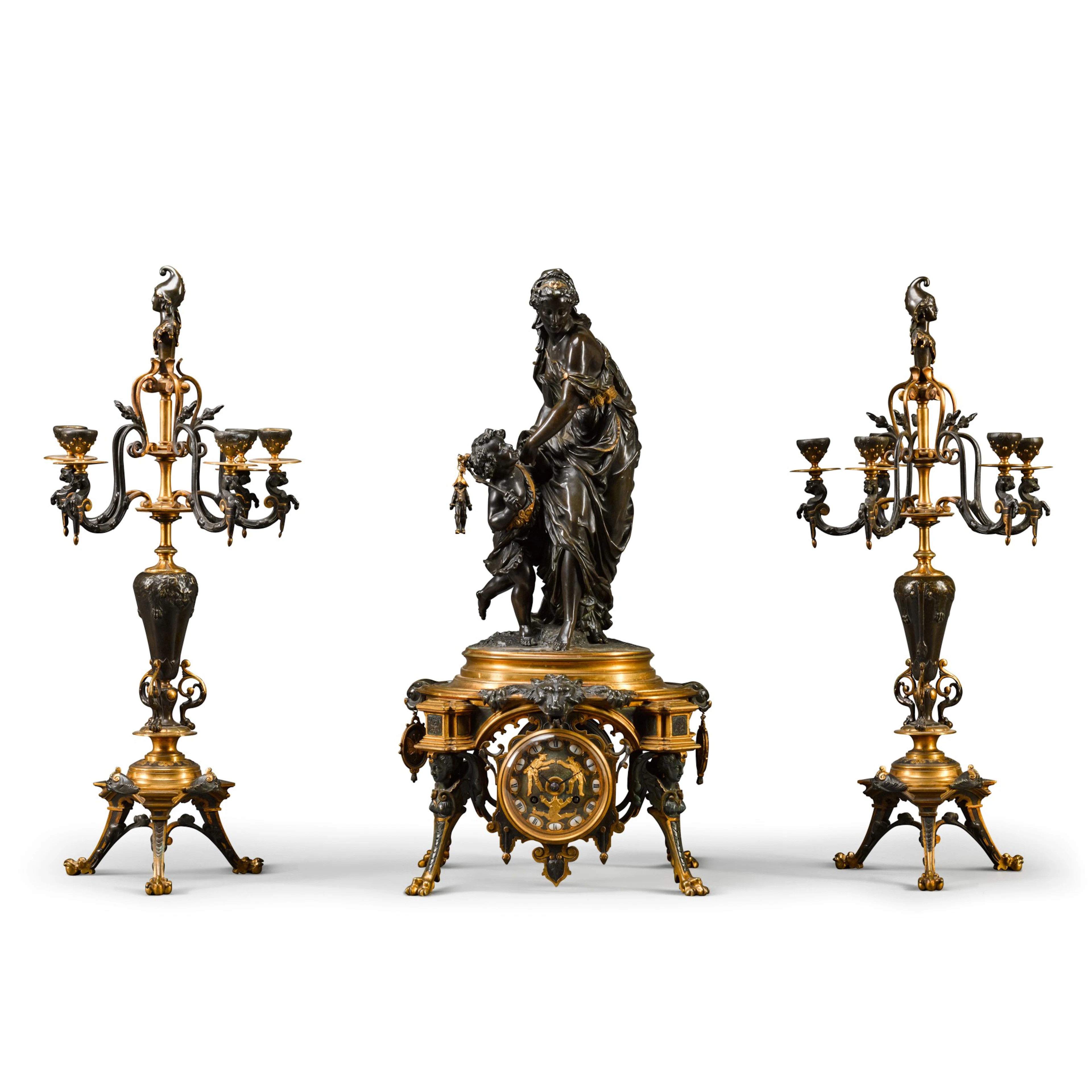 A gilt and patinated bronze three-piece clock garniture
