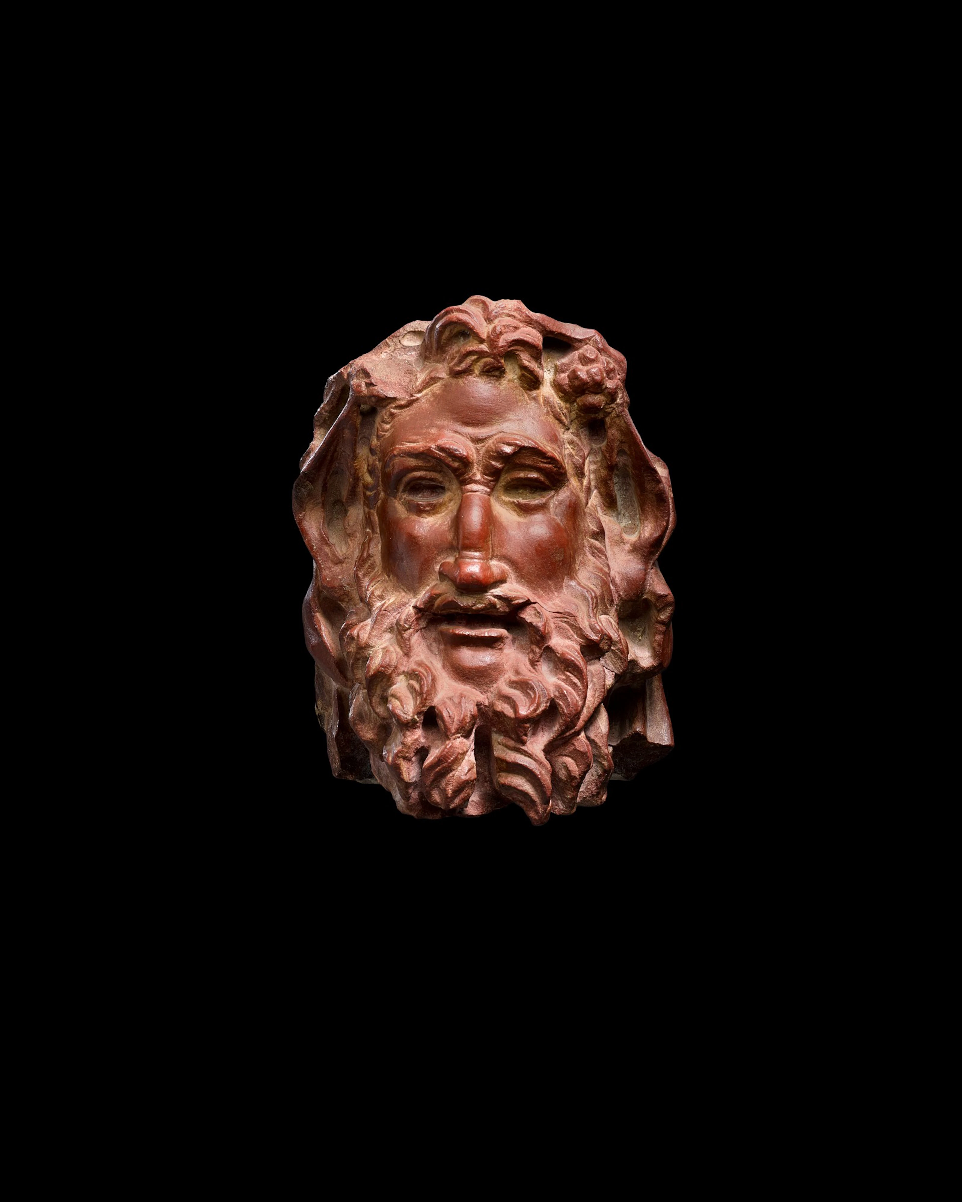 A Rosso Antico Marble Herm Head of a Satyr, circa 2nd Century A.D.