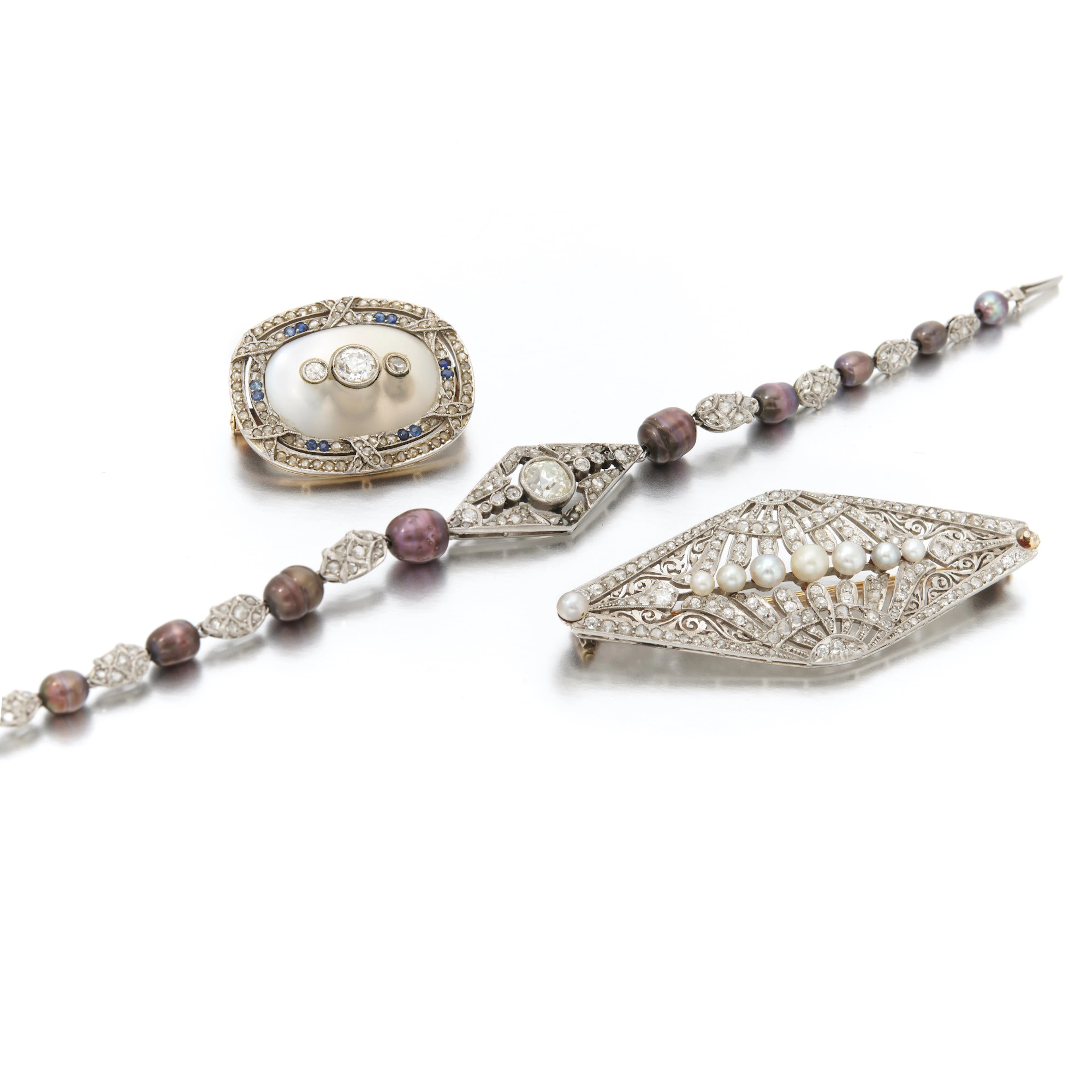 Diamond and cultured pearl bracelet and two brooches...