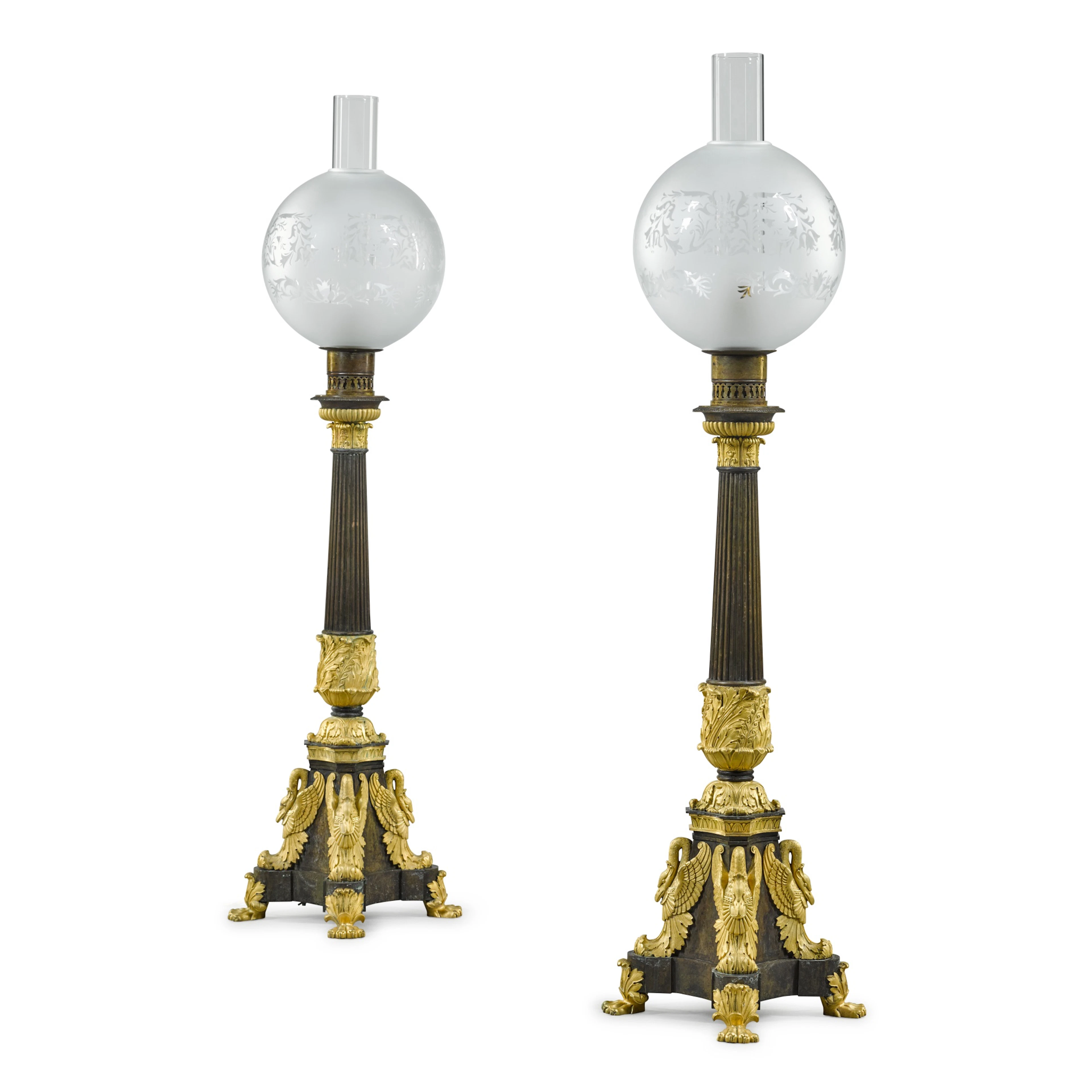 A pair of Russian gilt and patinated bronze oil lamps