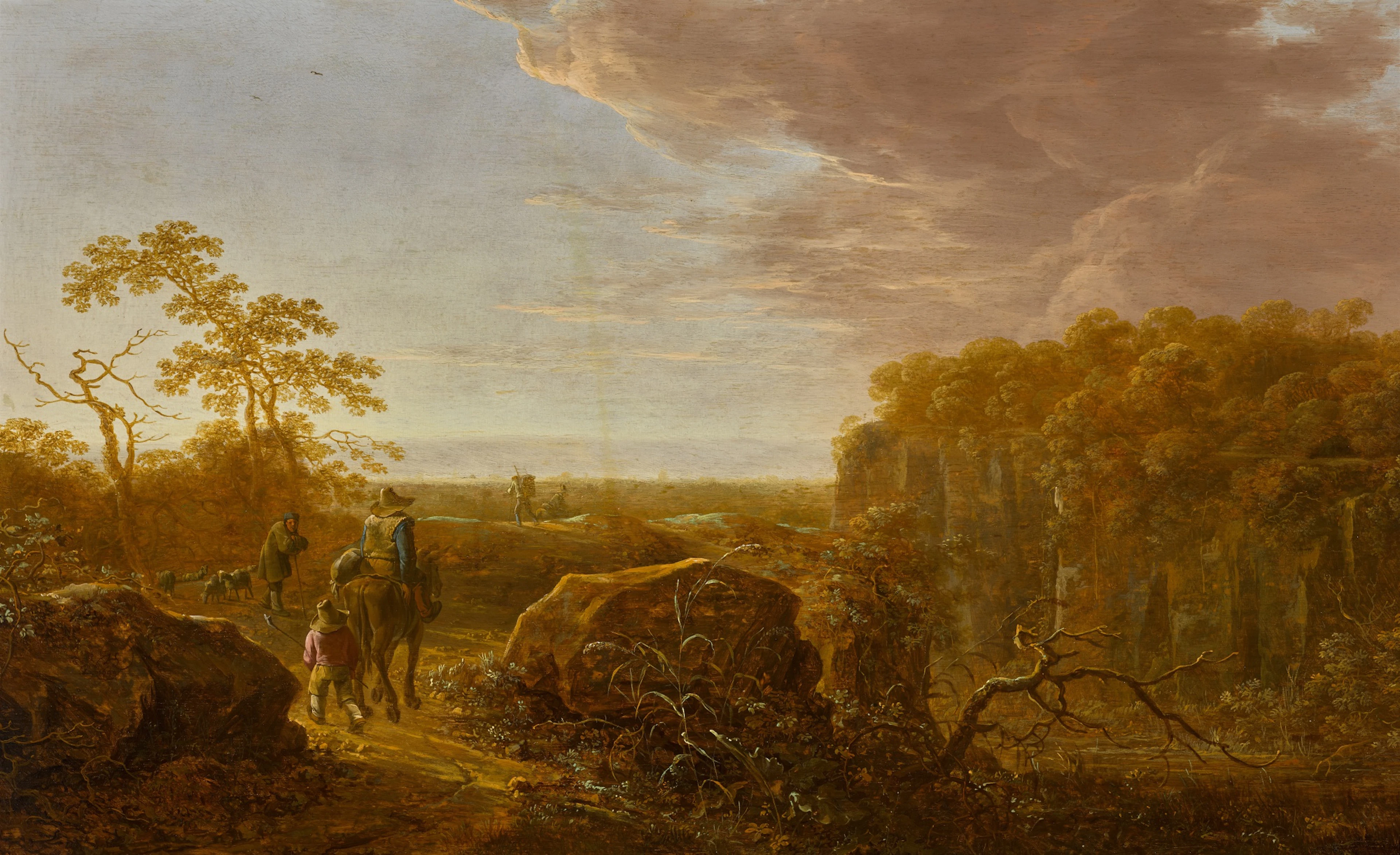 An italianate rocky landscape with a horseman and a child on a path