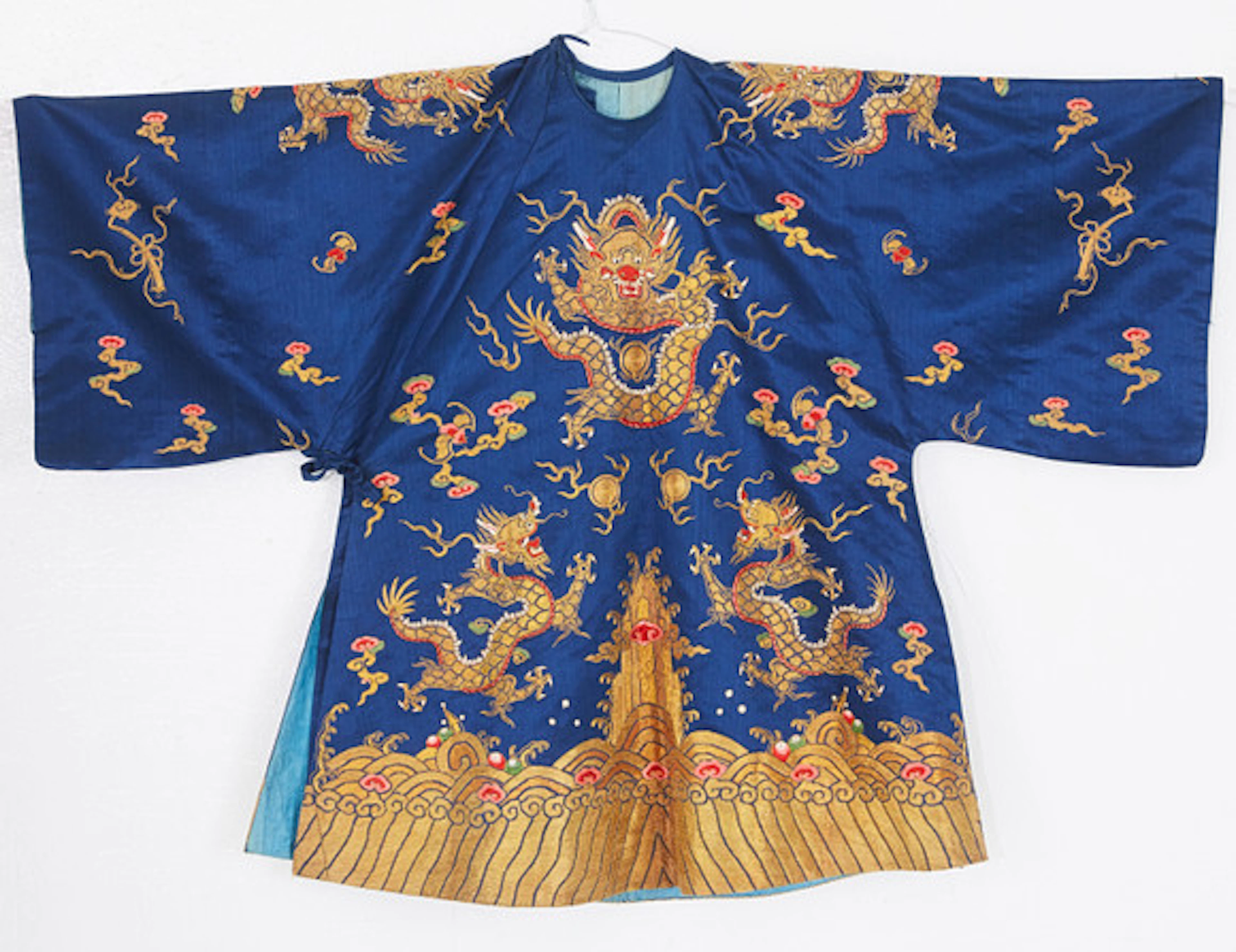 A BLUE-GROUND SILK BROCADE CHILDREN'S ROBE…