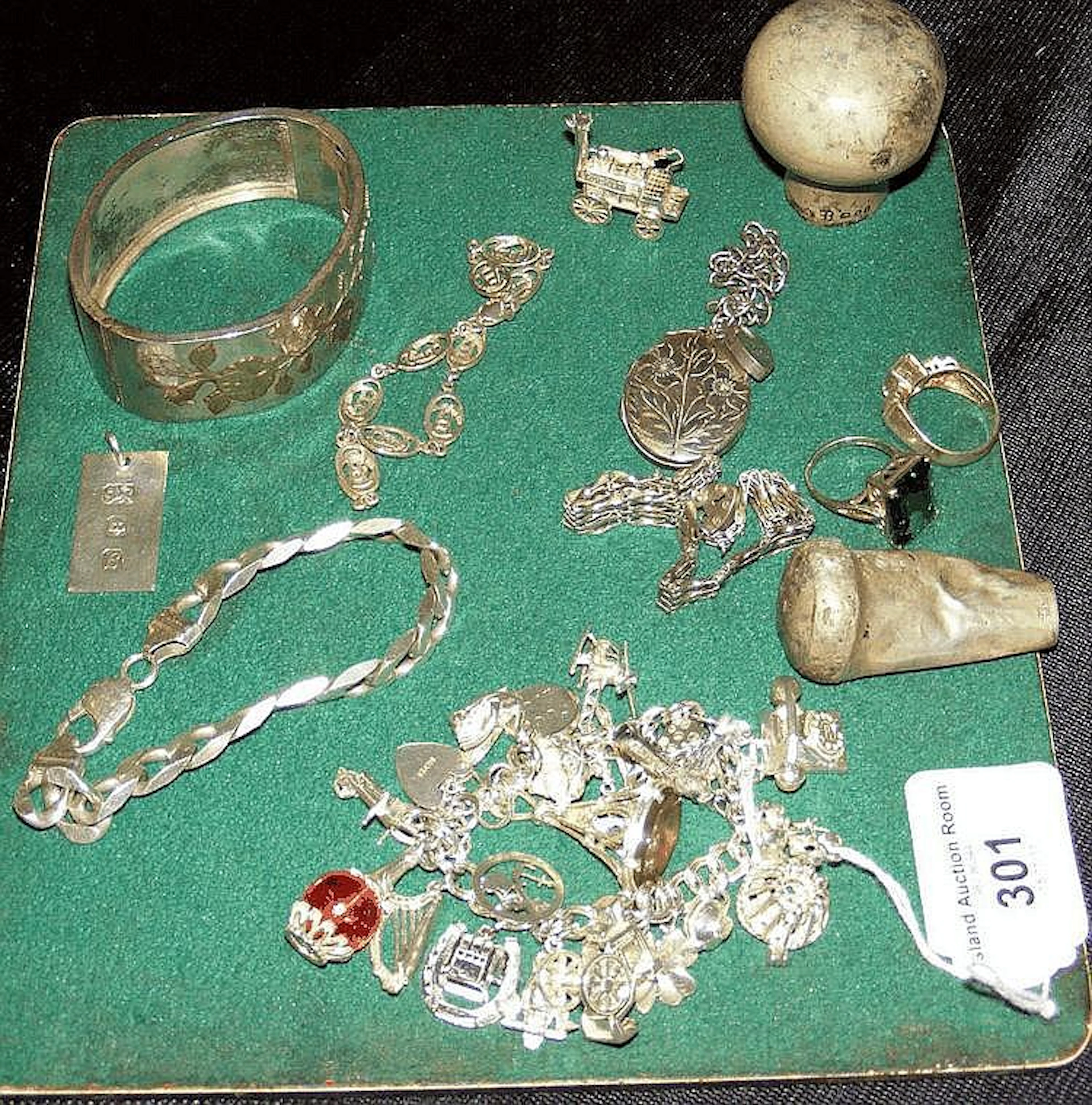 A silver charm bracelet with various charms and a