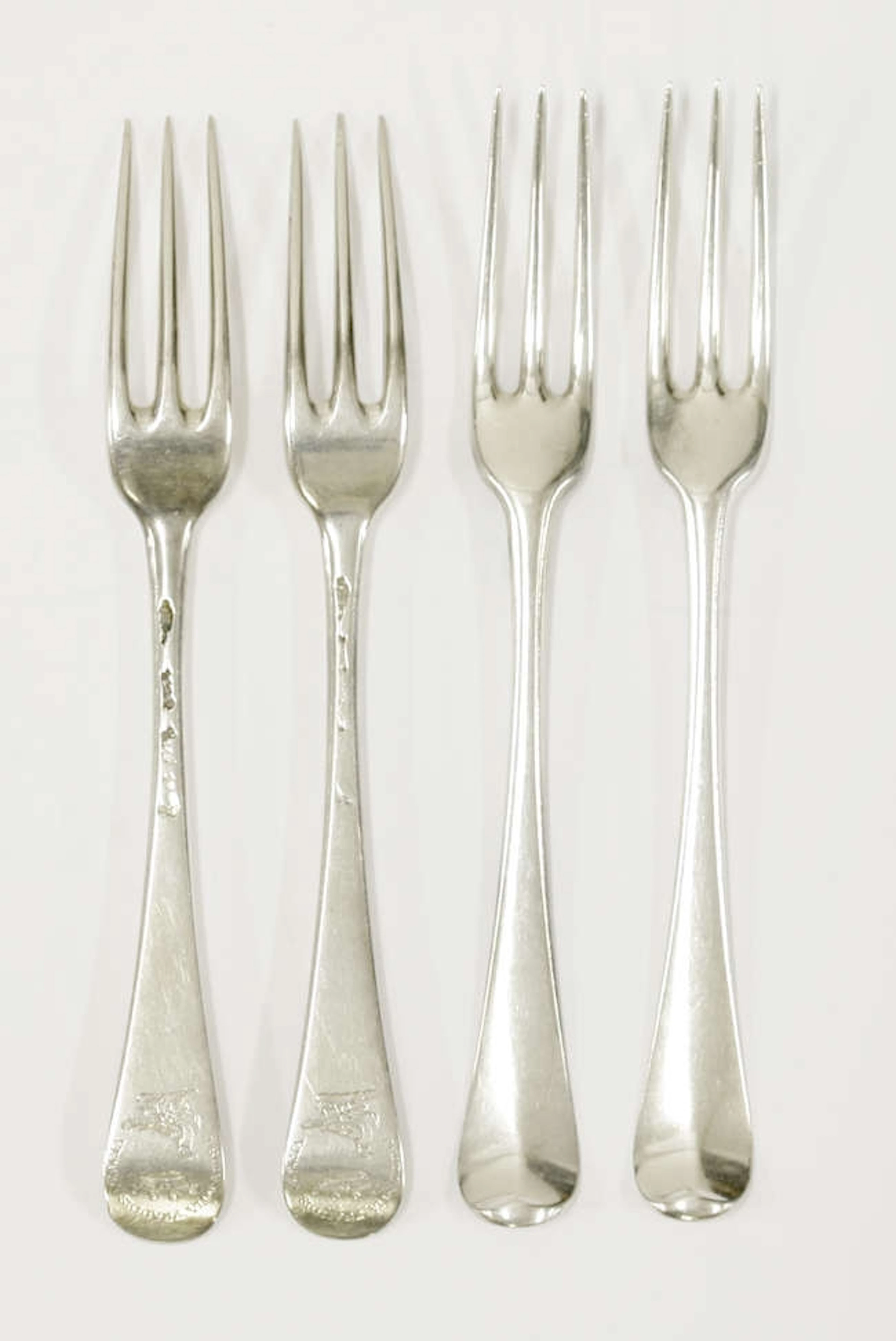 A set of twelve George II silver hanoverian pattern three prong dessert forks