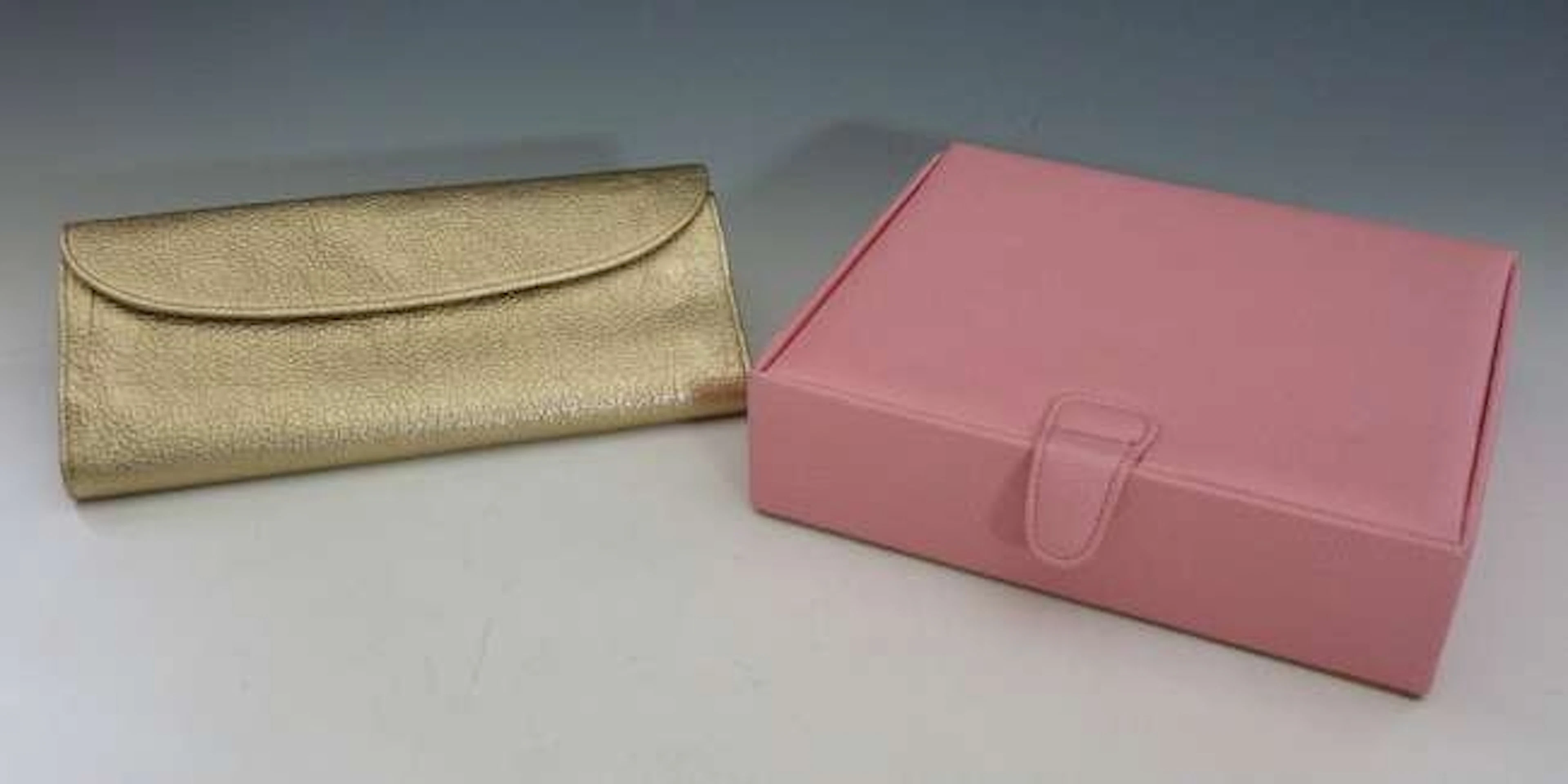 A Harry Winston gold metallic leather jewellery roll