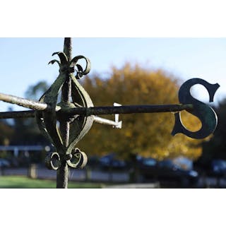 A wrought-iron and brass weather vane