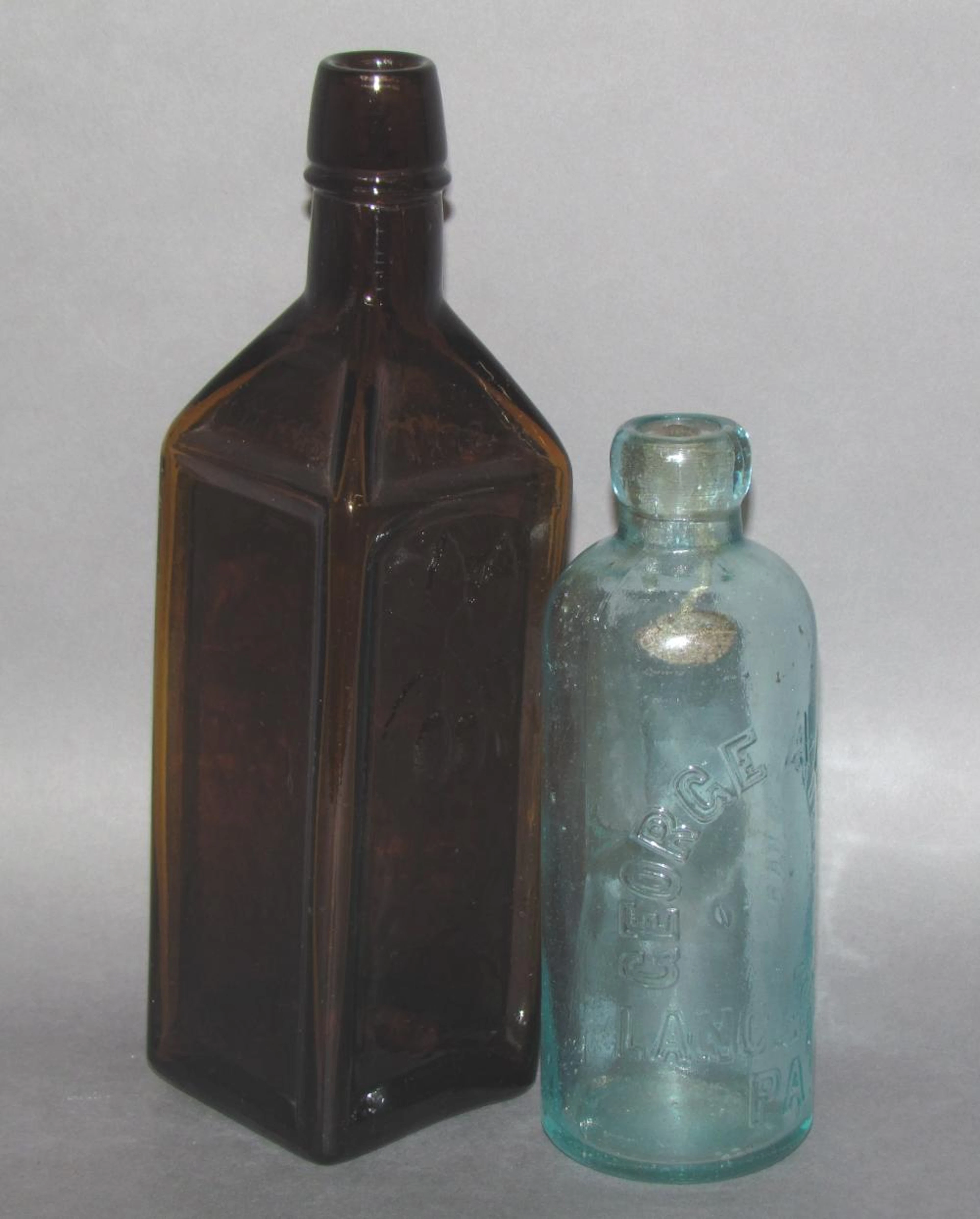 2 blown in a mold glass bottles