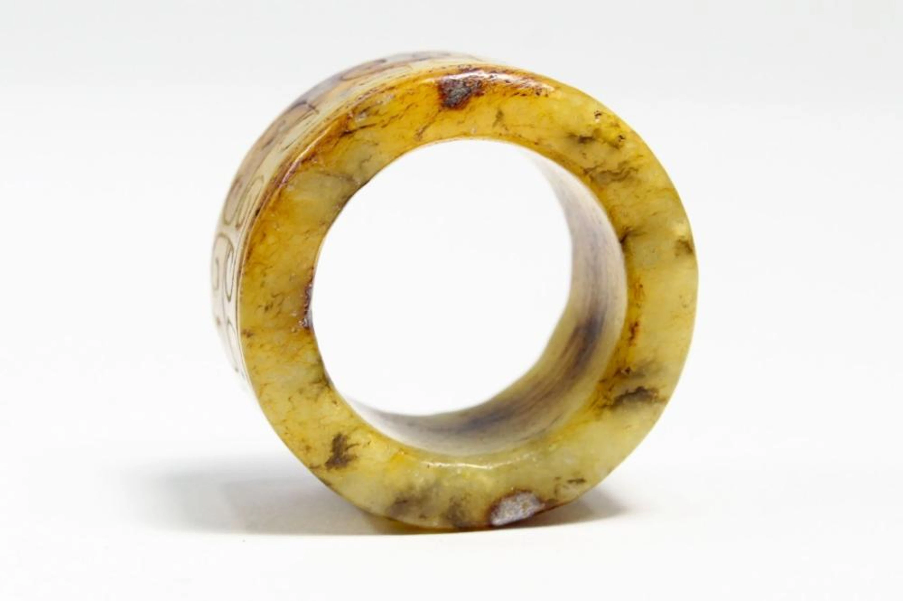 CHINESE GREEN BROWN JADE ARCHER RING INCISED DES