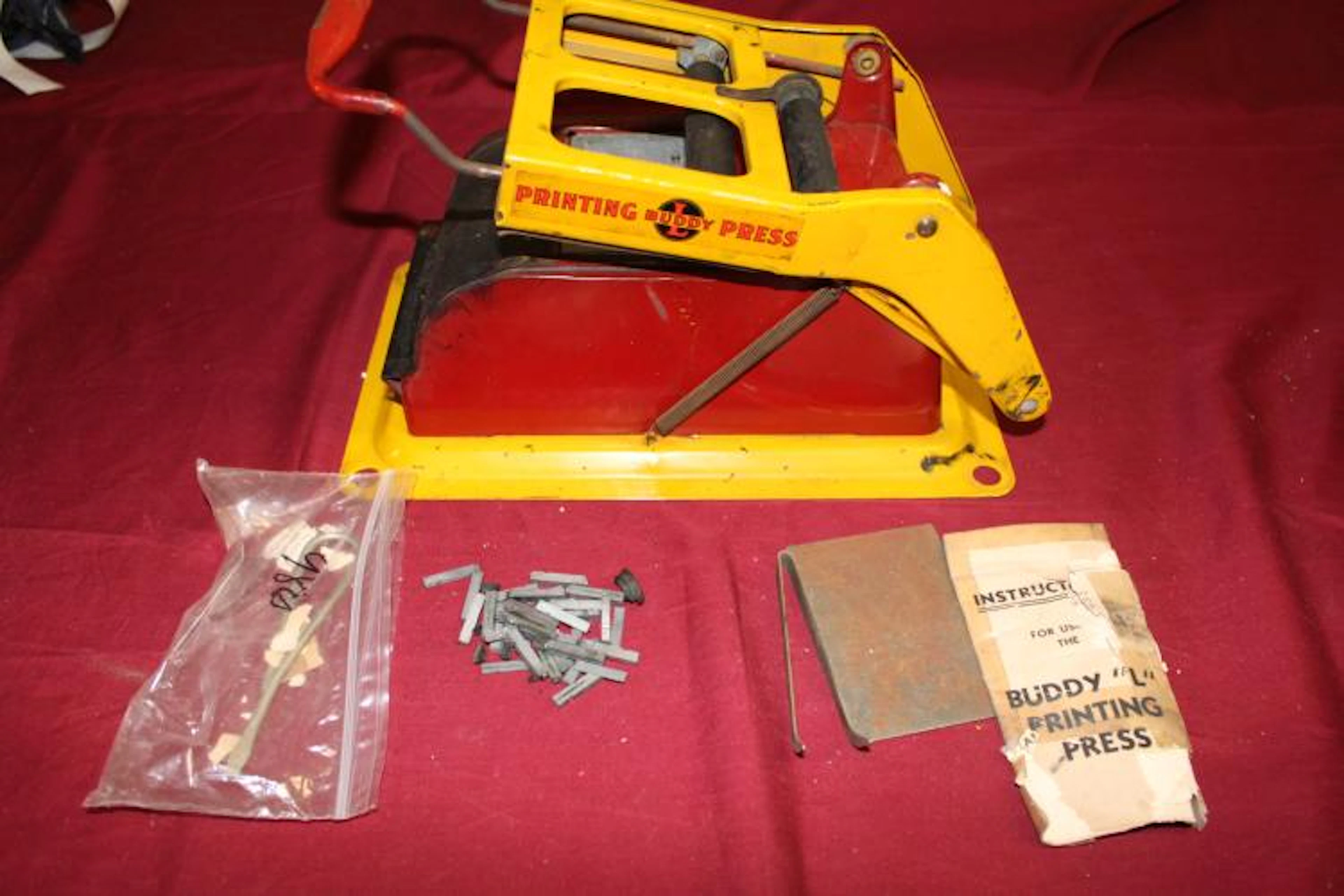 1910 Buddy L Printing press with metal printing stamps and instructions