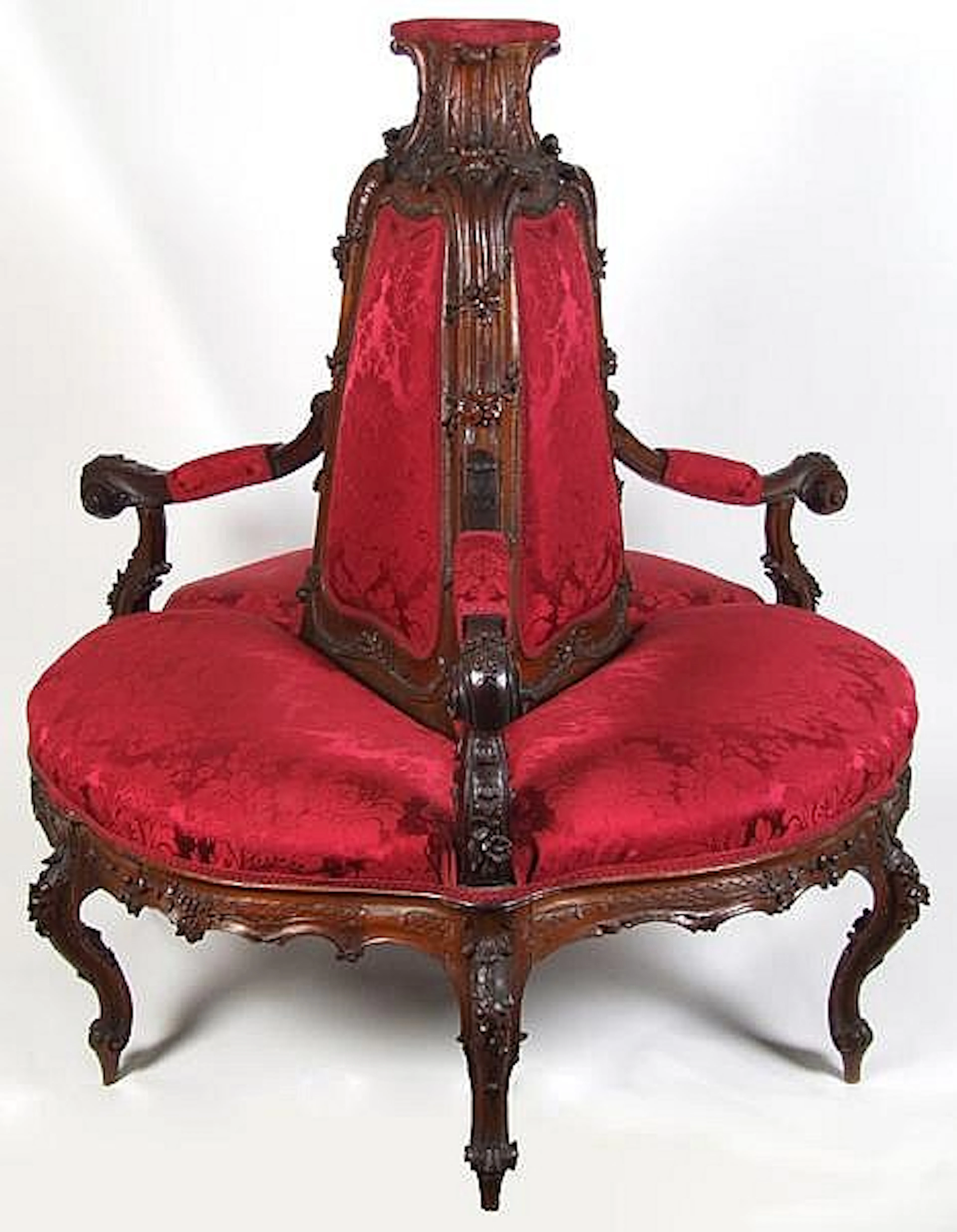 LOUIS XV STYLE CAUSEUSE (Late 19th-early 20th c.) Causeuse or tete-a-tete. Highly carved walnut frame. Floral decorated red silk damask upholstery