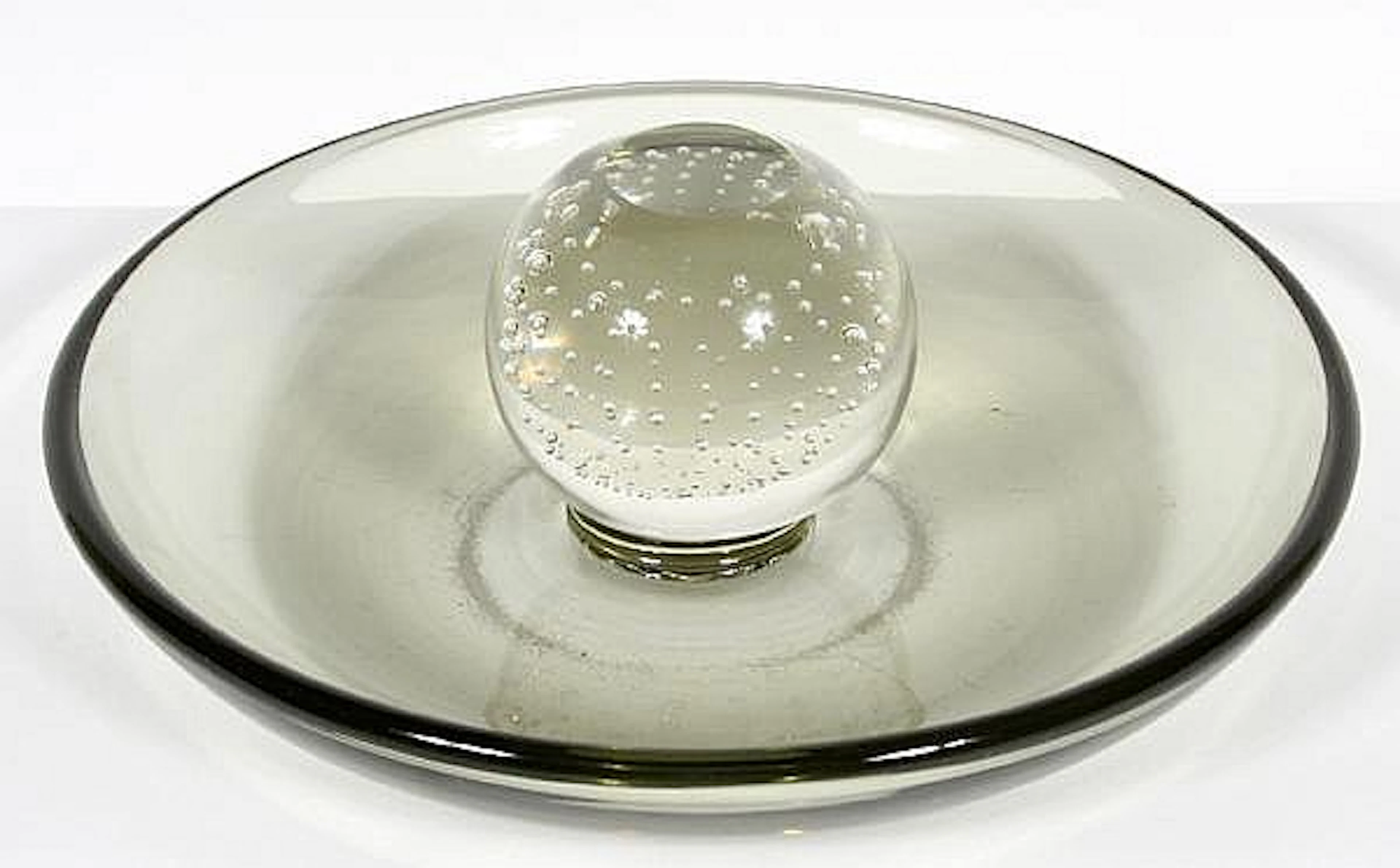ERICKSON PIPE ASHTRAY. Erickson free hand art glass ashtray, smoke colored bowl with clear controlled air bubble paperweight center ball with flat top. No mark. Size: 3''H, 8 1/4''Diam. widest part