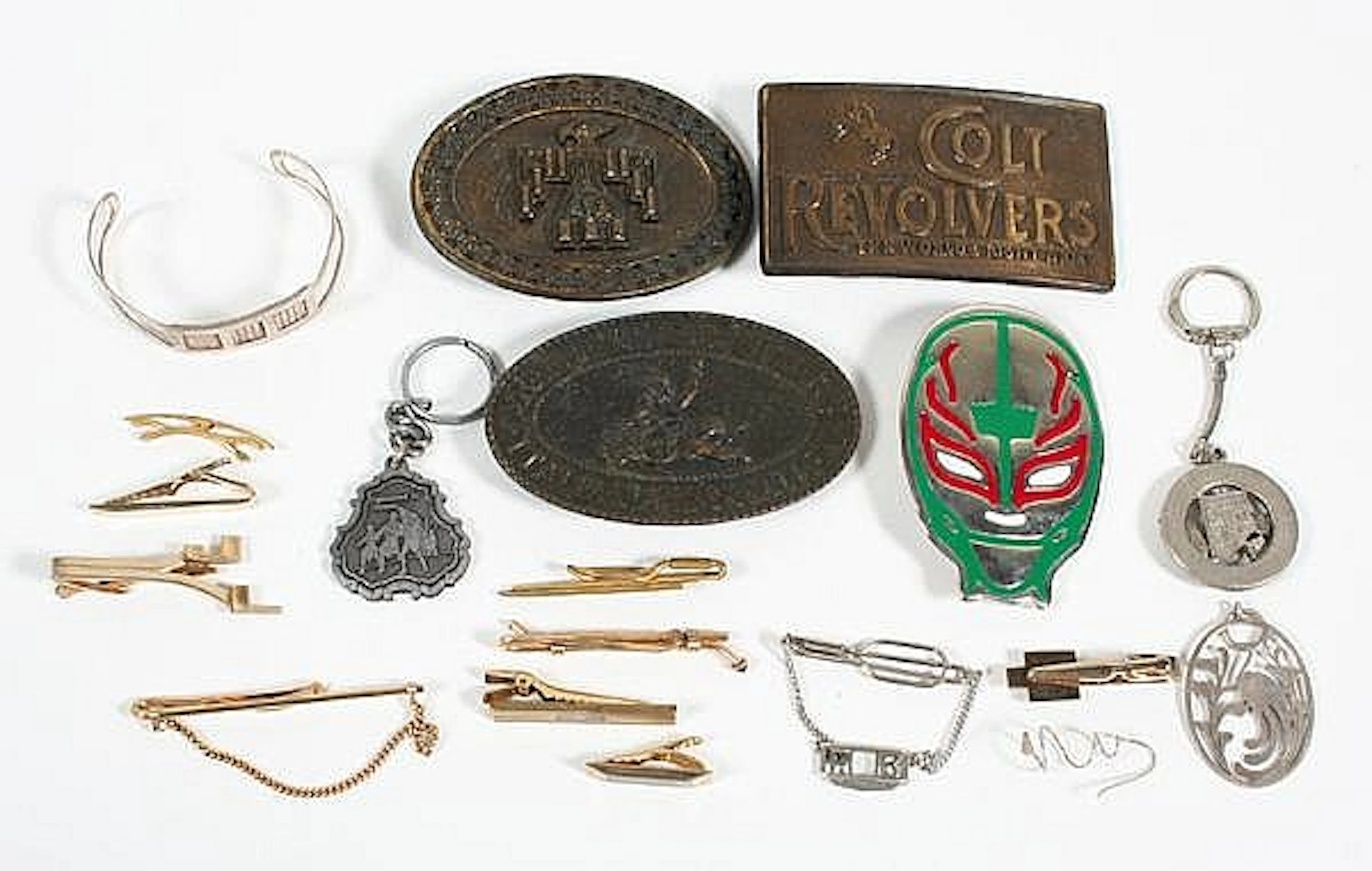 VINTAGE CUFFLINKS, CHARM BRACELETS, CHARMS, AND BELT BUCKLES. This lot includes: (1) handful of button studs. (34) tie clips. (6) pairs of matched cufflinks. (1) set of matched cufflinks and tie clip 