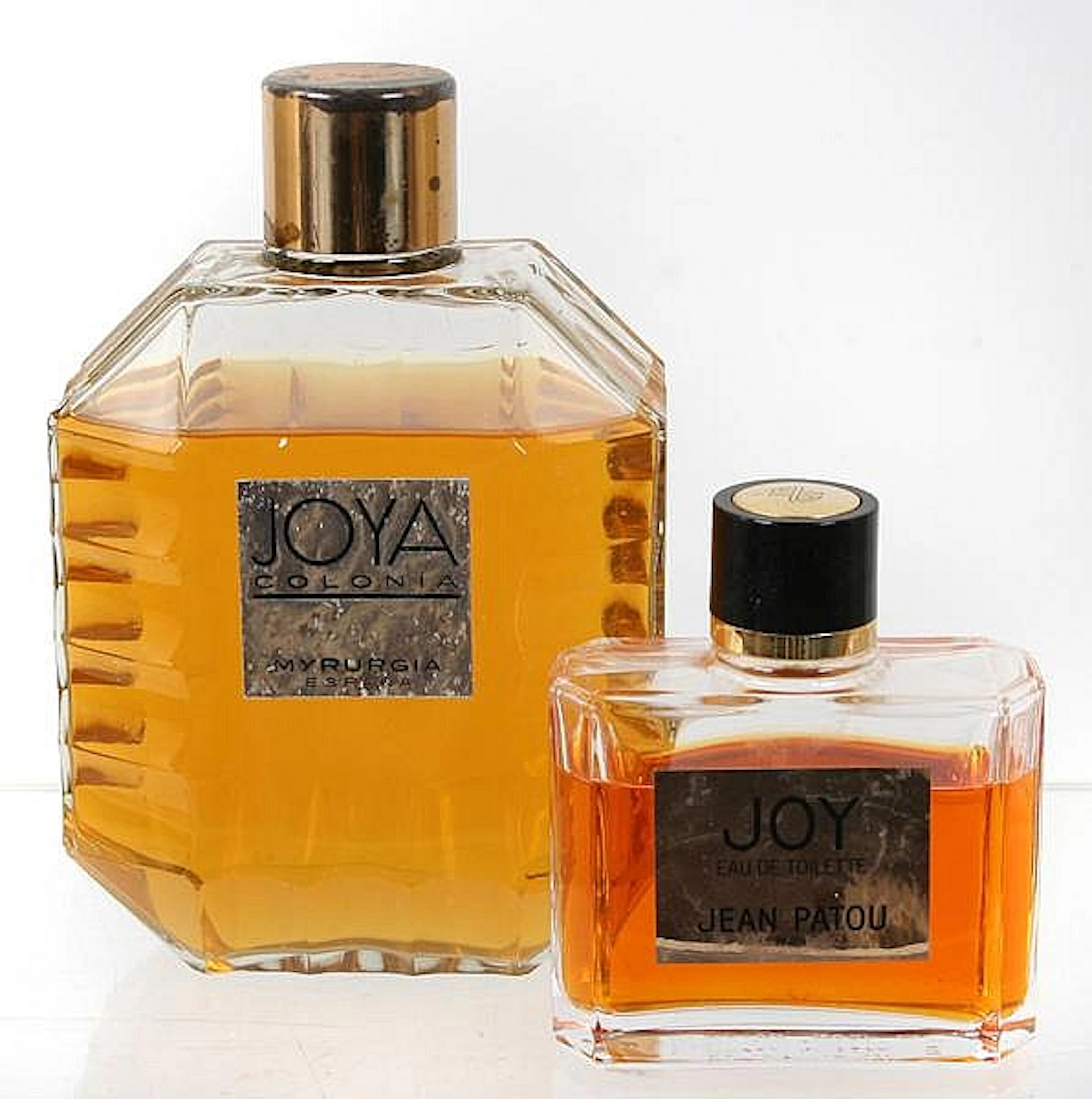 TWO VINTAGE PERFUMES. Lot includes: (1) Joy eau de Toilette by Jean Patou Paris, 1984 reorchestration of 1930 original . 4 fl. oz. Joy Eau de Toilette, clear bottle with plastic screw on cap