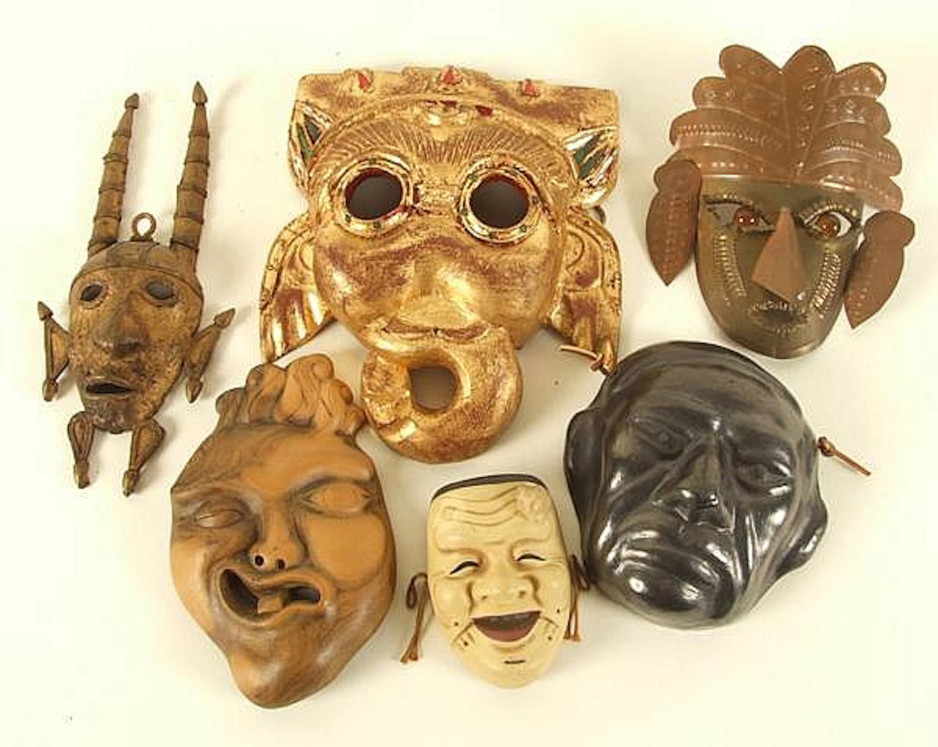 COLLECTION OF ETHNIC MASKS 6 PCS. (1) Kabuki mask. Laughing face. Ceramic. No mark. Size: 4 1/8''H. Condition: missing application on forehead. (1) Black ceramic face mask. Mark: tag: Acapulco Mexico 