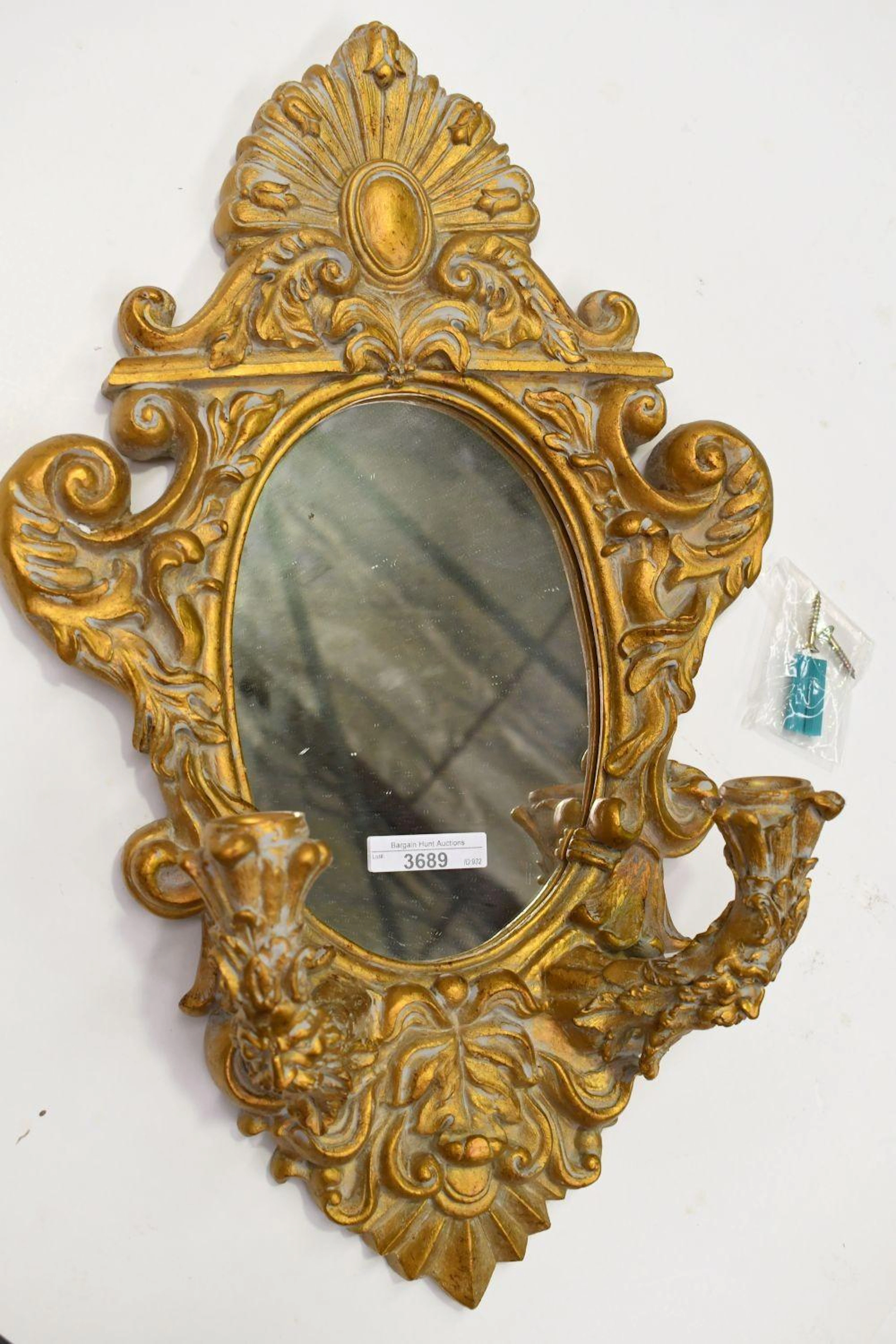 Modern gilt wall mirror with twin candelabra sconce detail