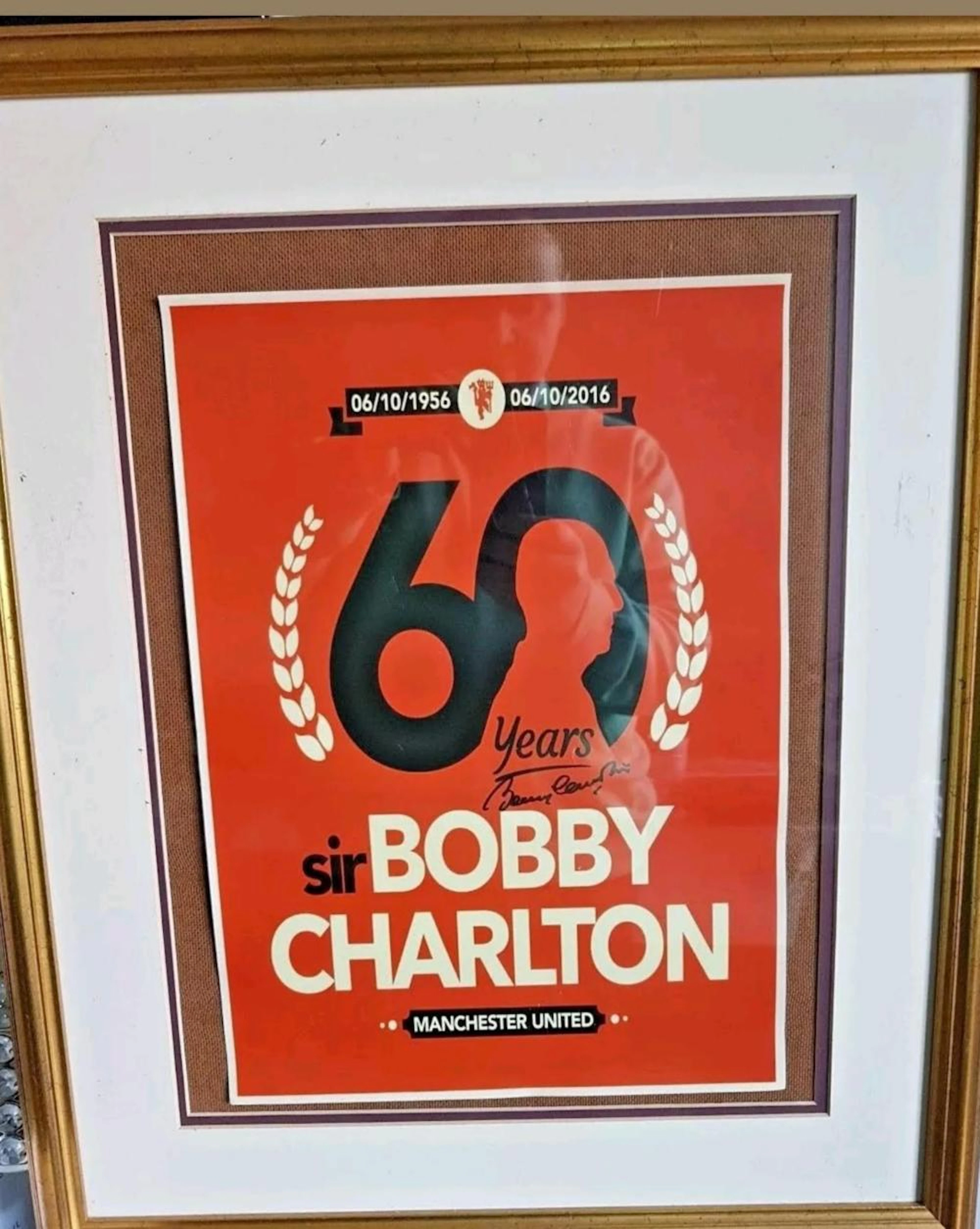 Lot 114 - Signed poster of Sir Bobby Charlton celebrating...