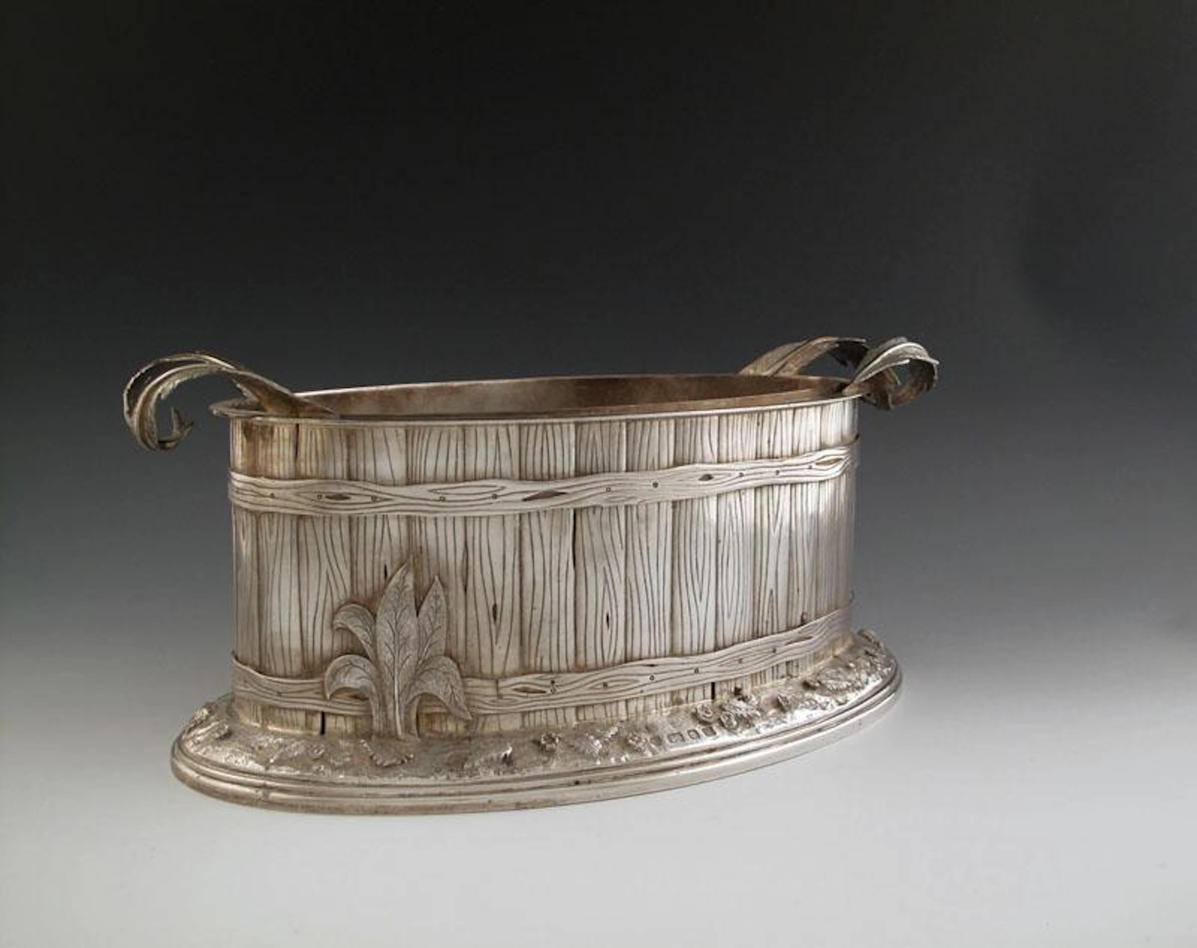 A modern silver jardinière / wine cooler