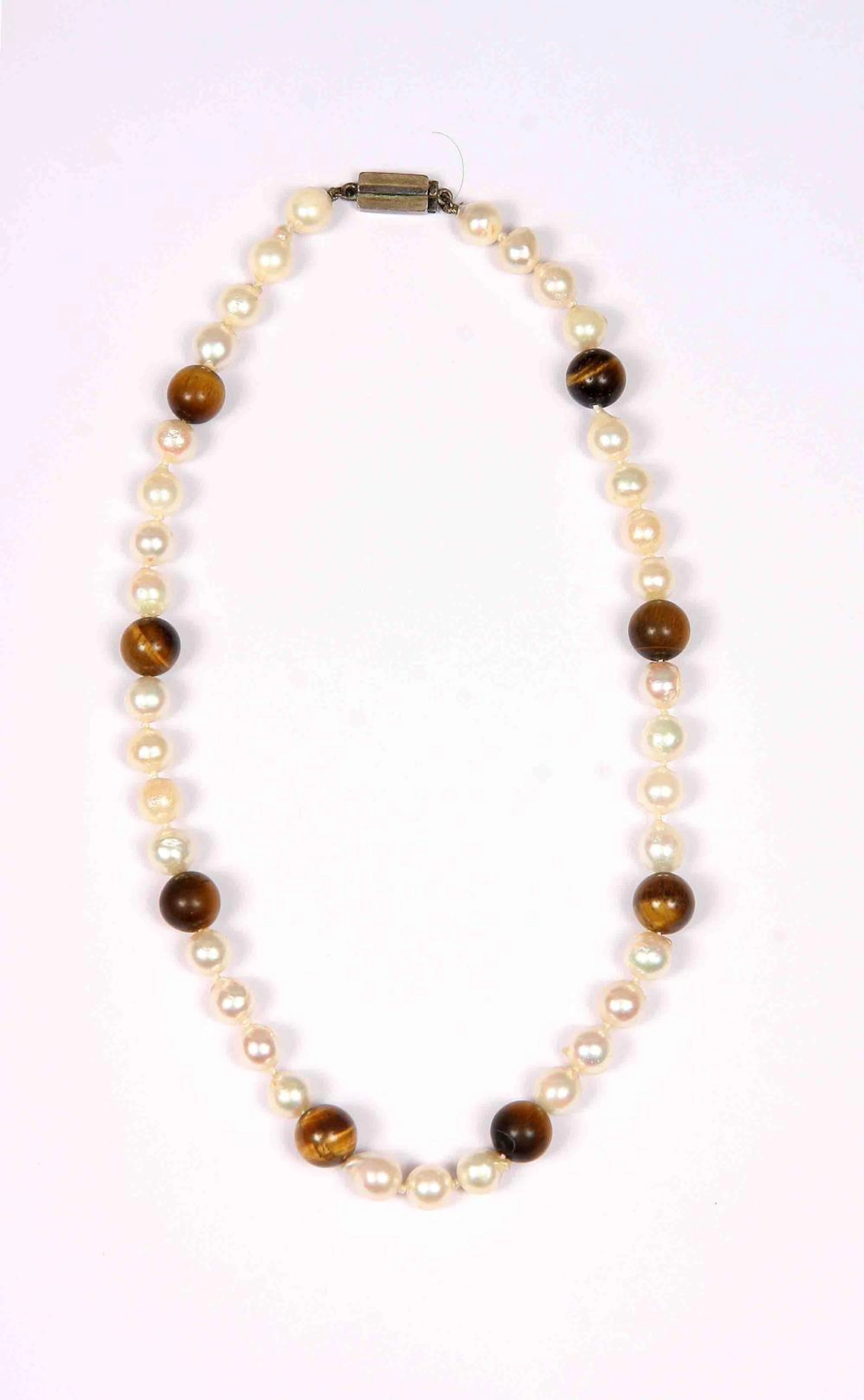 Majorica pearl choker and tiger eye beads.