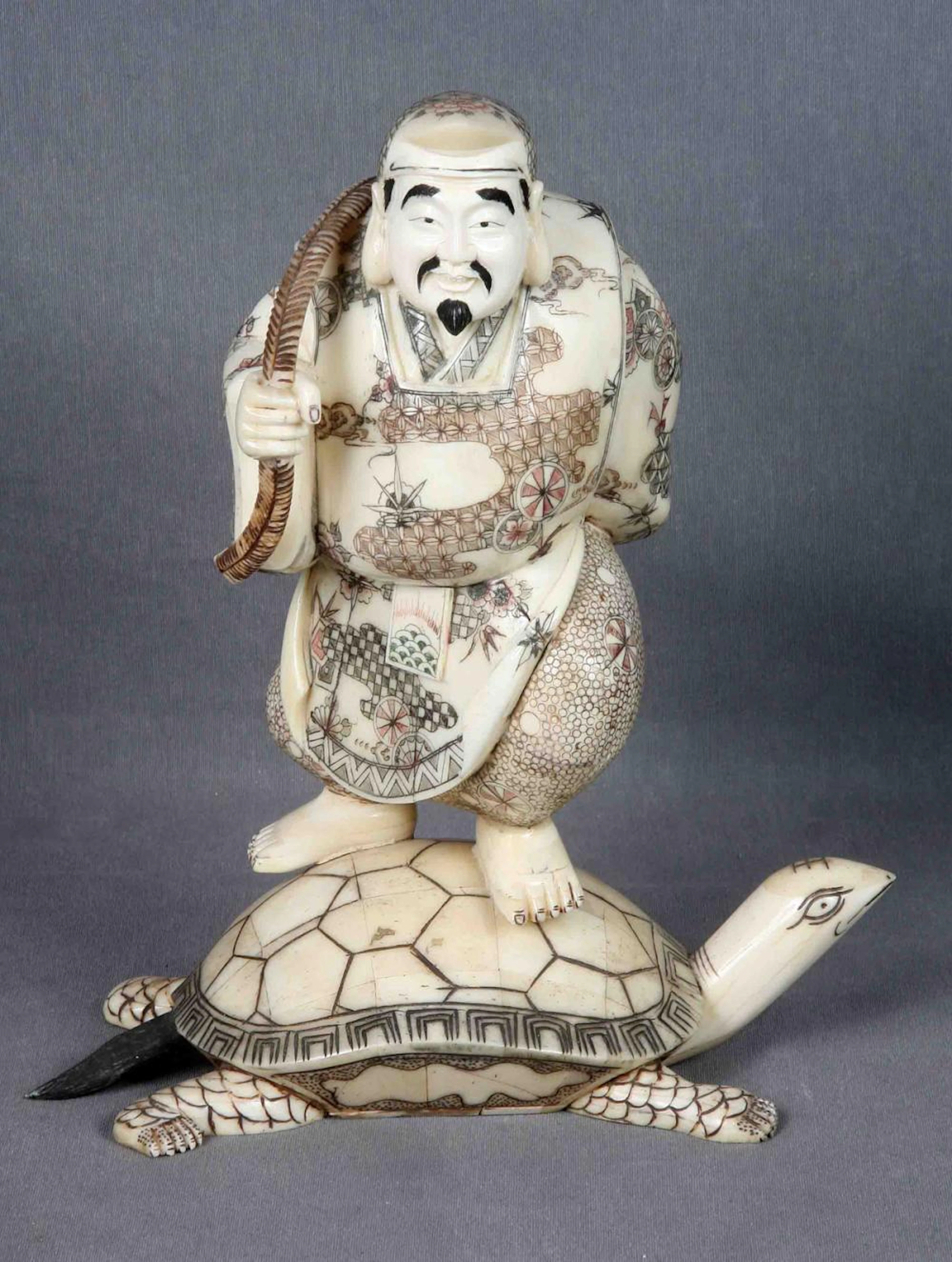 Figura oriental de pescador sobre tortuga. Figura