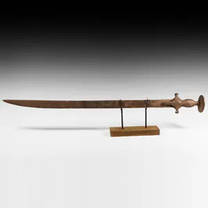 An Indian Tulwar sword with fullered, curved blade with a single edge ...