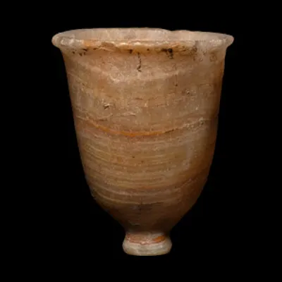 A piriform veined alabaster cup with everted rim and small foot. | Barnebys
