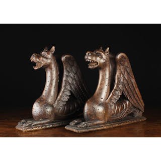 A Pair of Antique Carved Recumbent Griffins with...