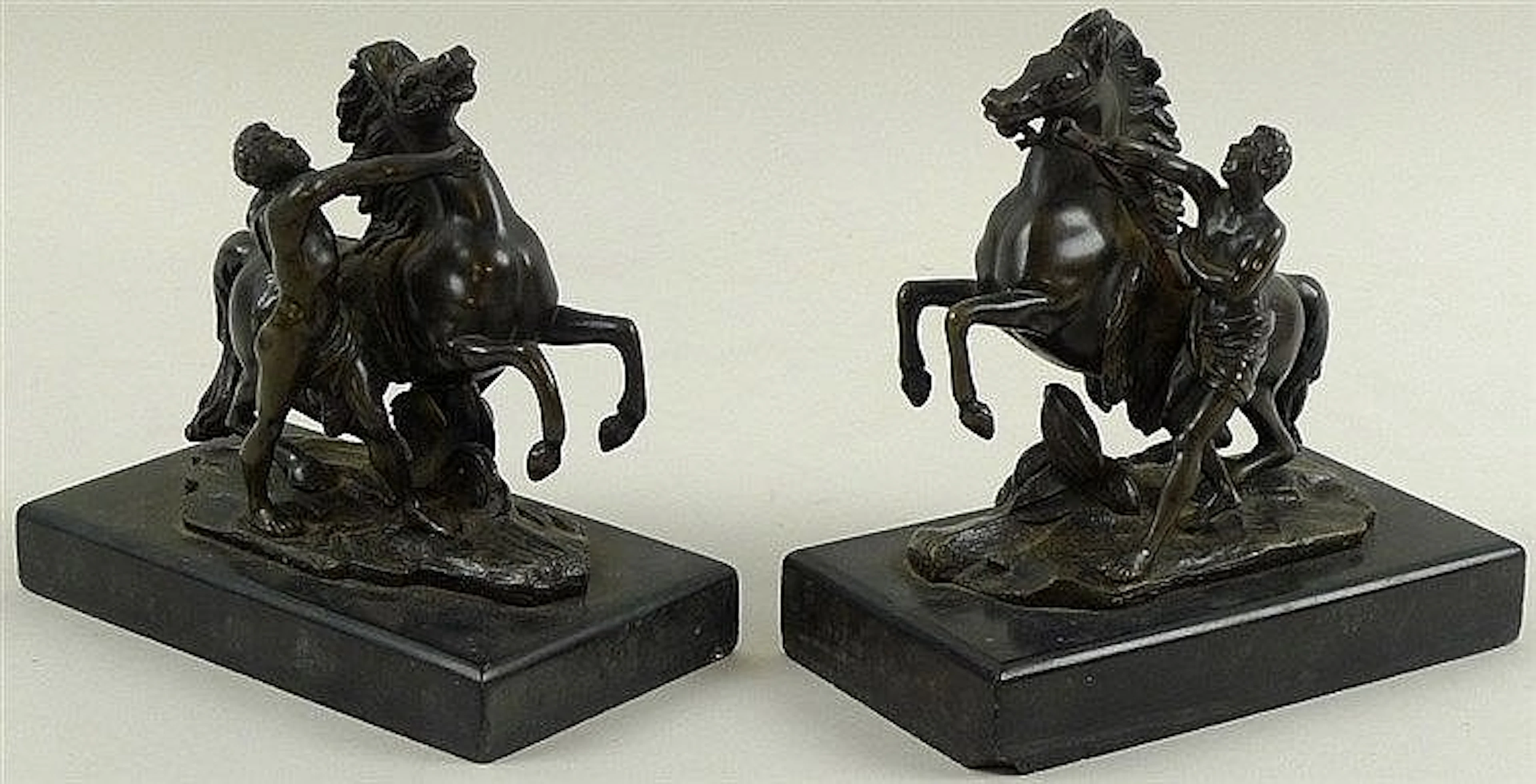 A pair of 19th century bronze figures of the Marly horses with attendants,