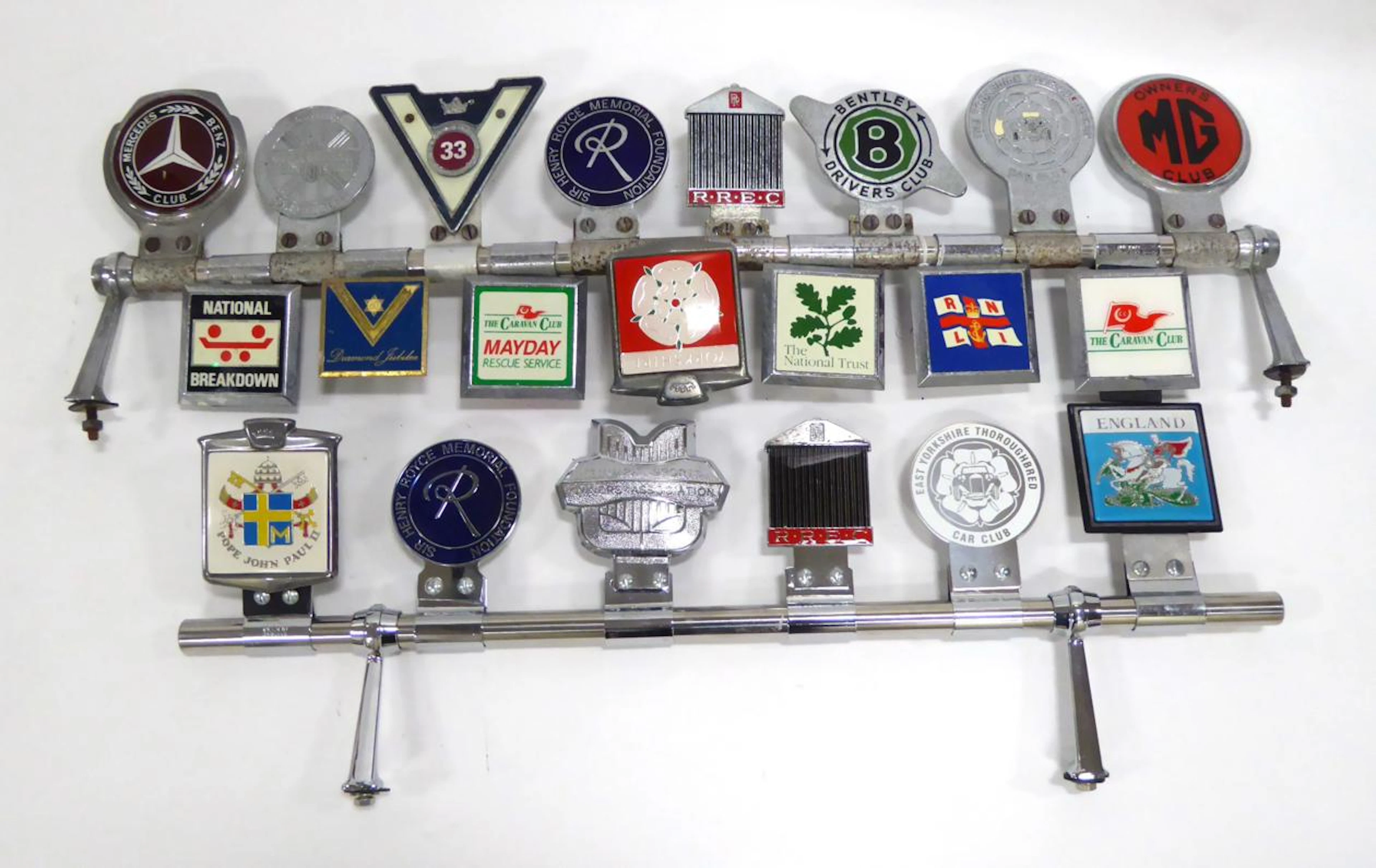 Twenty-One Car Badges some removed from a Panther Kallista