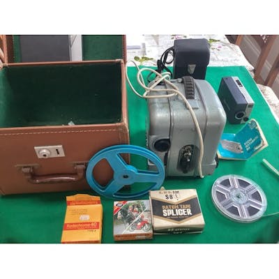 A 1960/70s projector in a box with a broken lock and a cased... | Barnebys