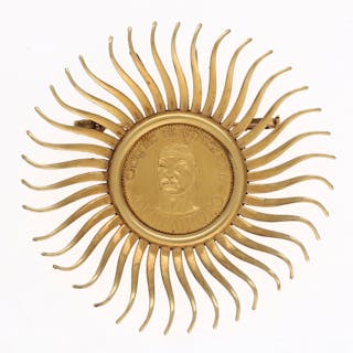 Sun-shaped brooch-pendant with a Venezuela coin.
