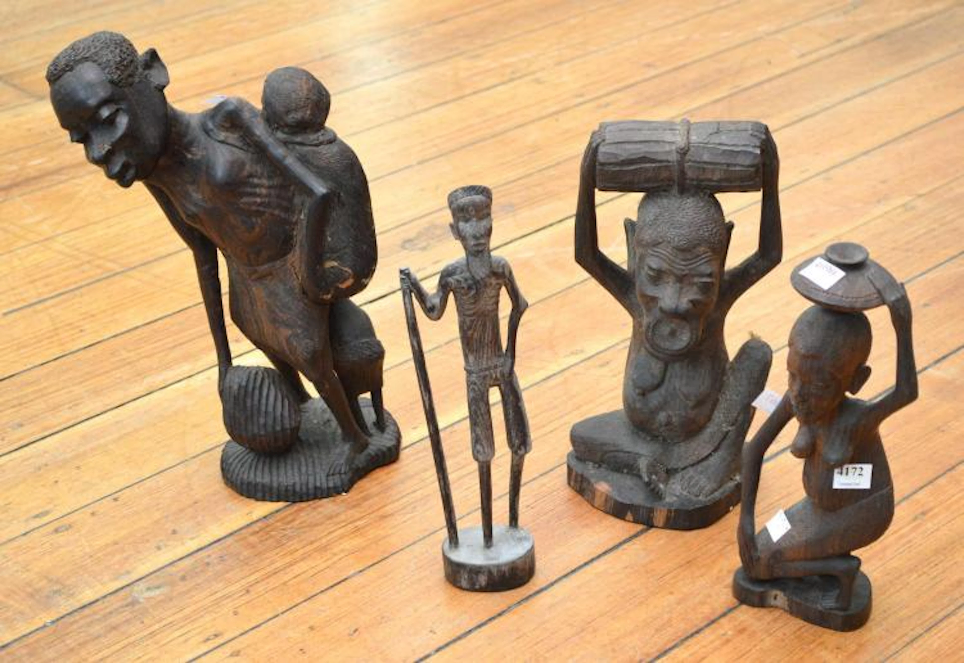 FOUR TANZANIAN MAKONDE WOODEN FIGURAL STATUES