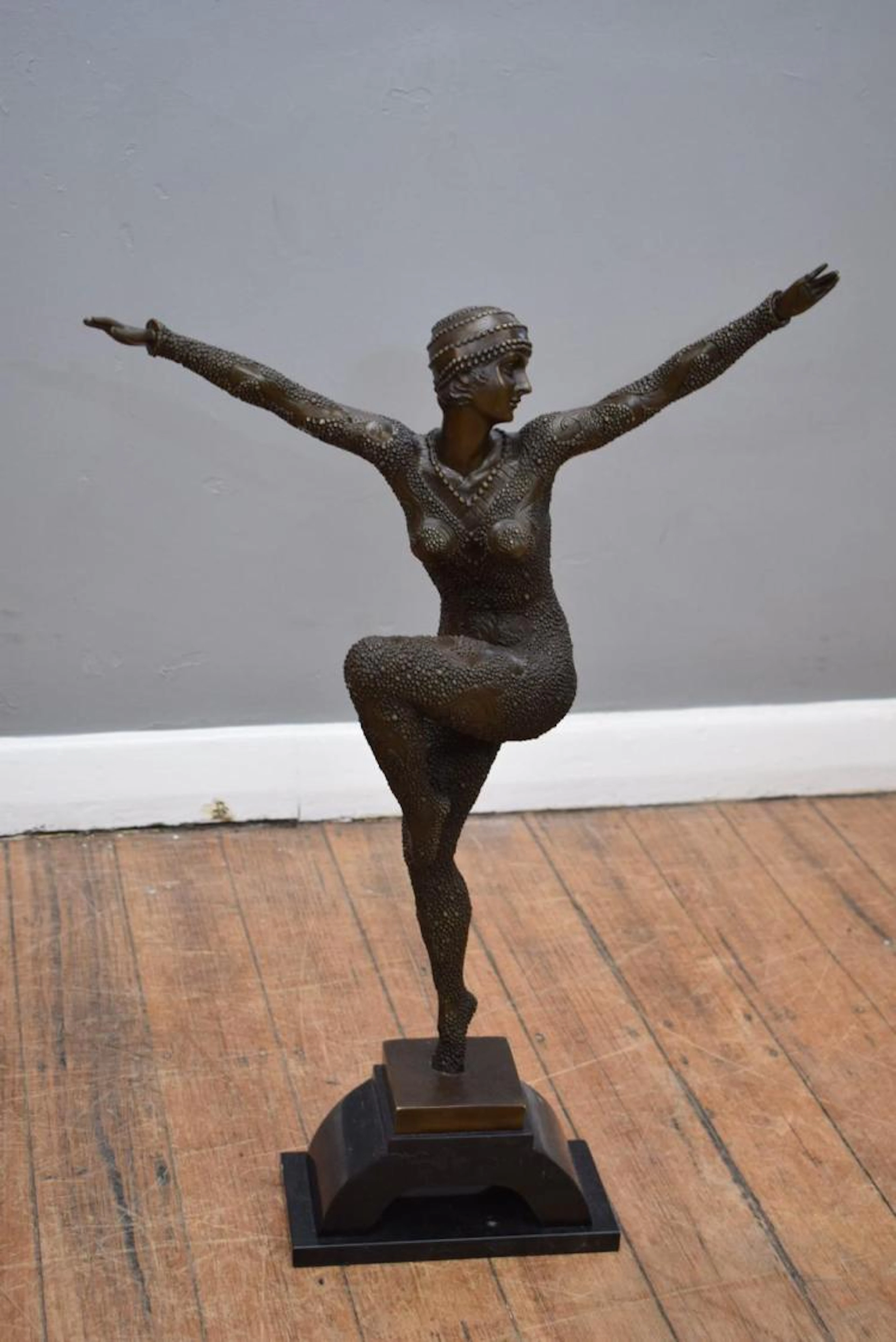 A BRONZE ''DANCER OF KARPATHULA'' ON A MARBLE BASE IN THE STYLE OF ''DEMETRE H