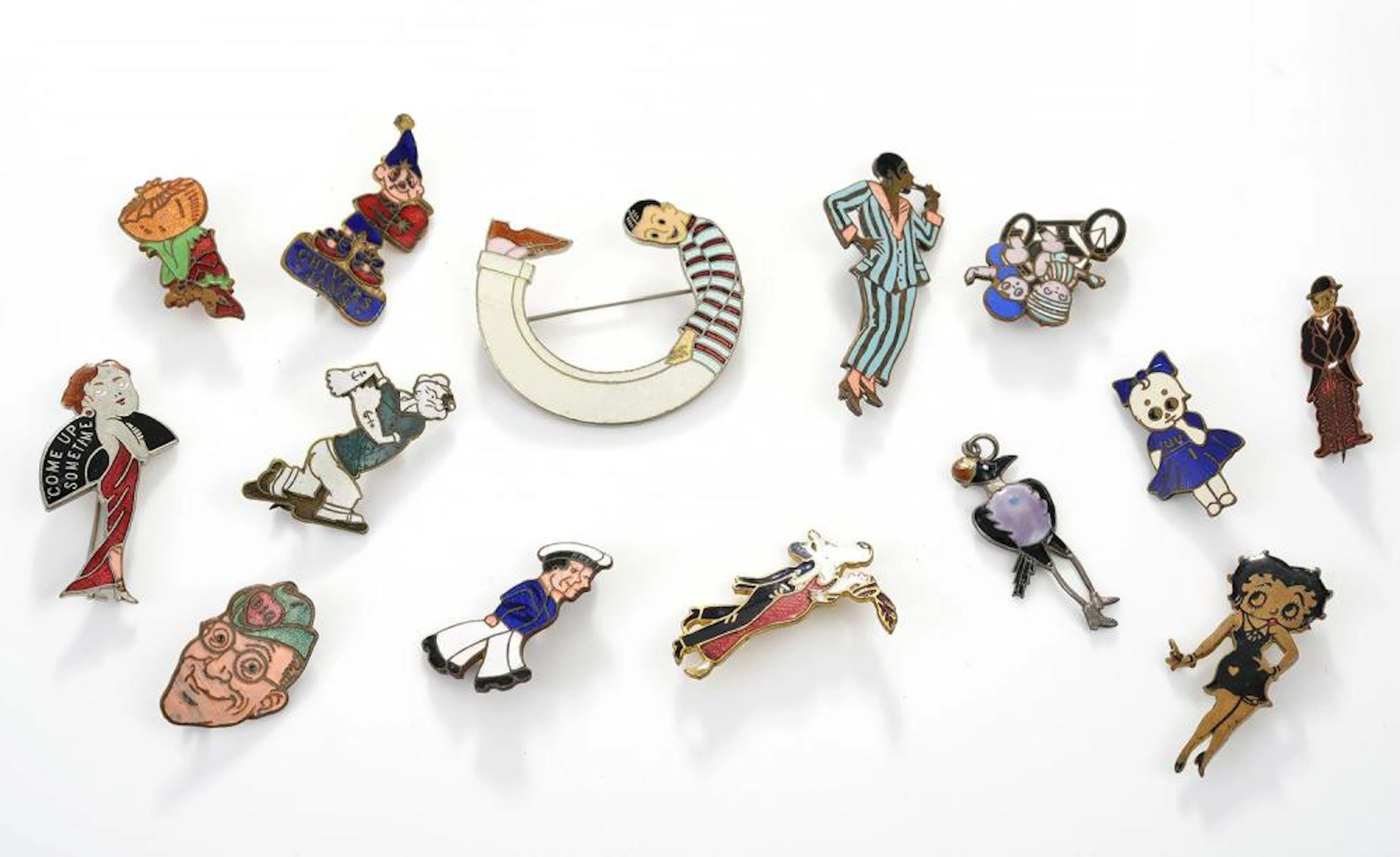 A COLLECTION OF VINTAGE COMIC AND NOVELTY ENAMEL BADGES...