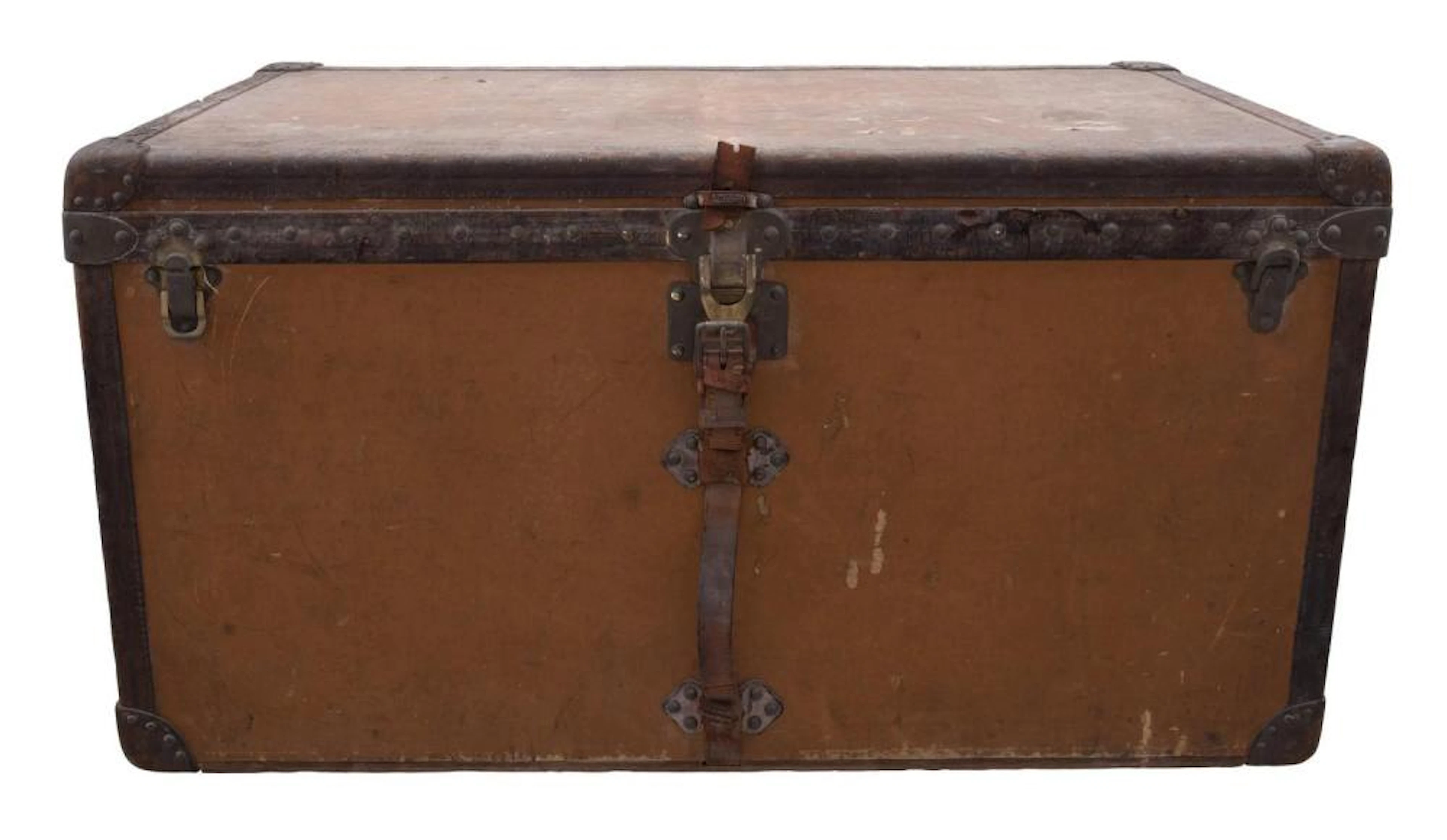 A VINTAGE ORANGE VUITTONITE CANVAS STEAMER TRUNK BY LOUIS VUITTON