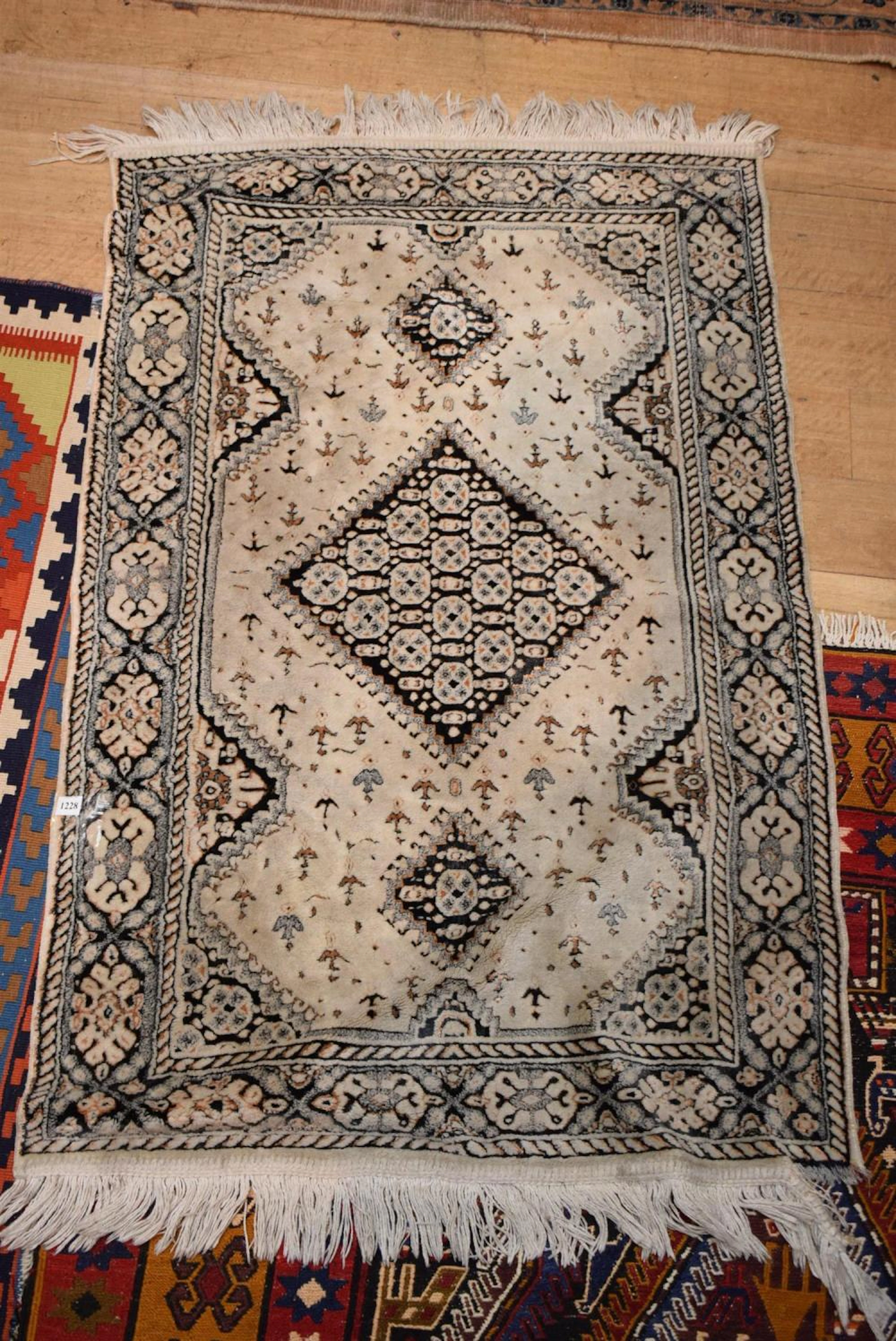 A MOROCCAN PRAYER RUG IN BLACK AND WHITE TONES
