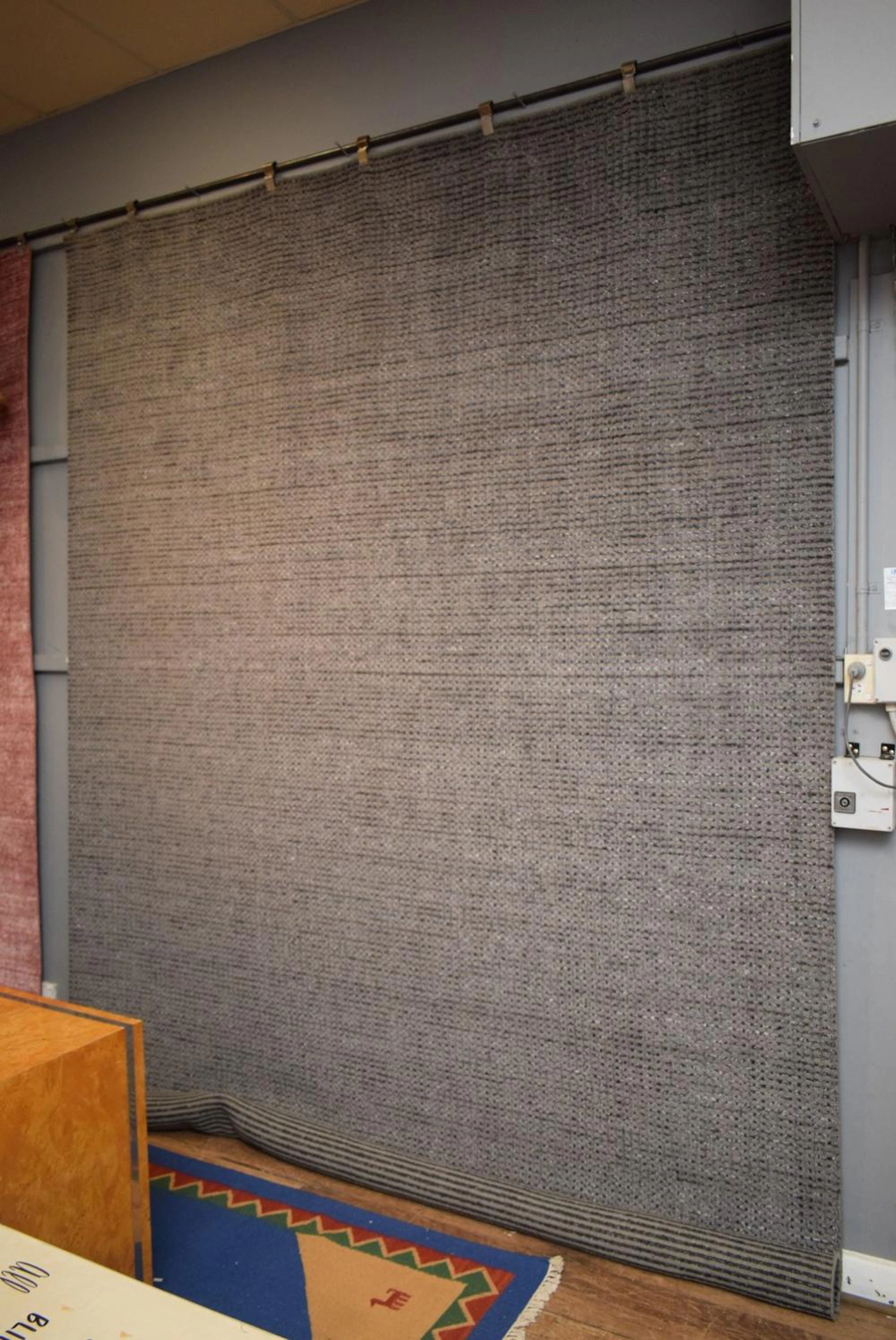 A MODERN LATTICE-PATTERNED CARPET IN TONES OF BEIGE