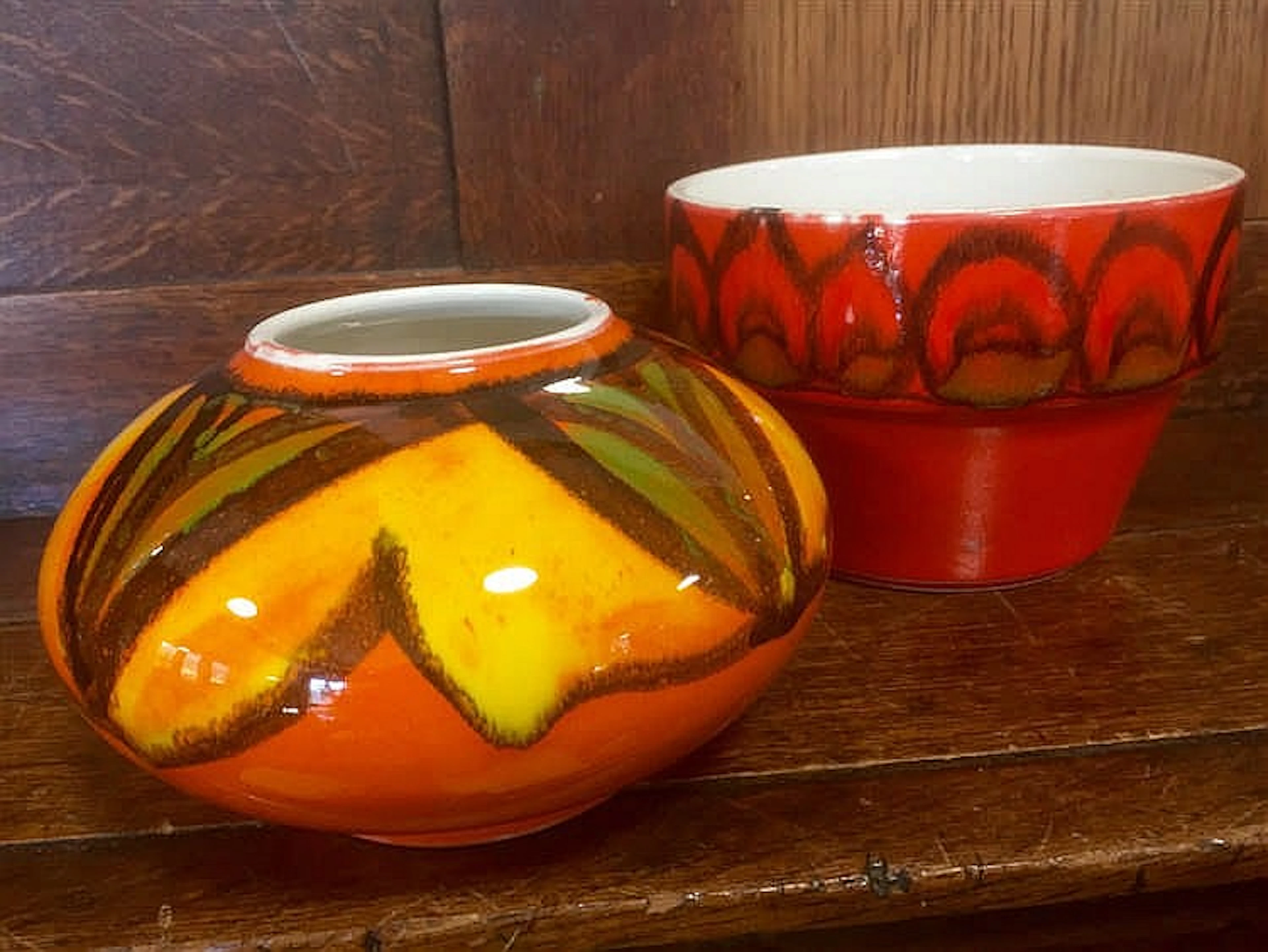 Poole flower pot in vibrant orange and black with dolphin mark