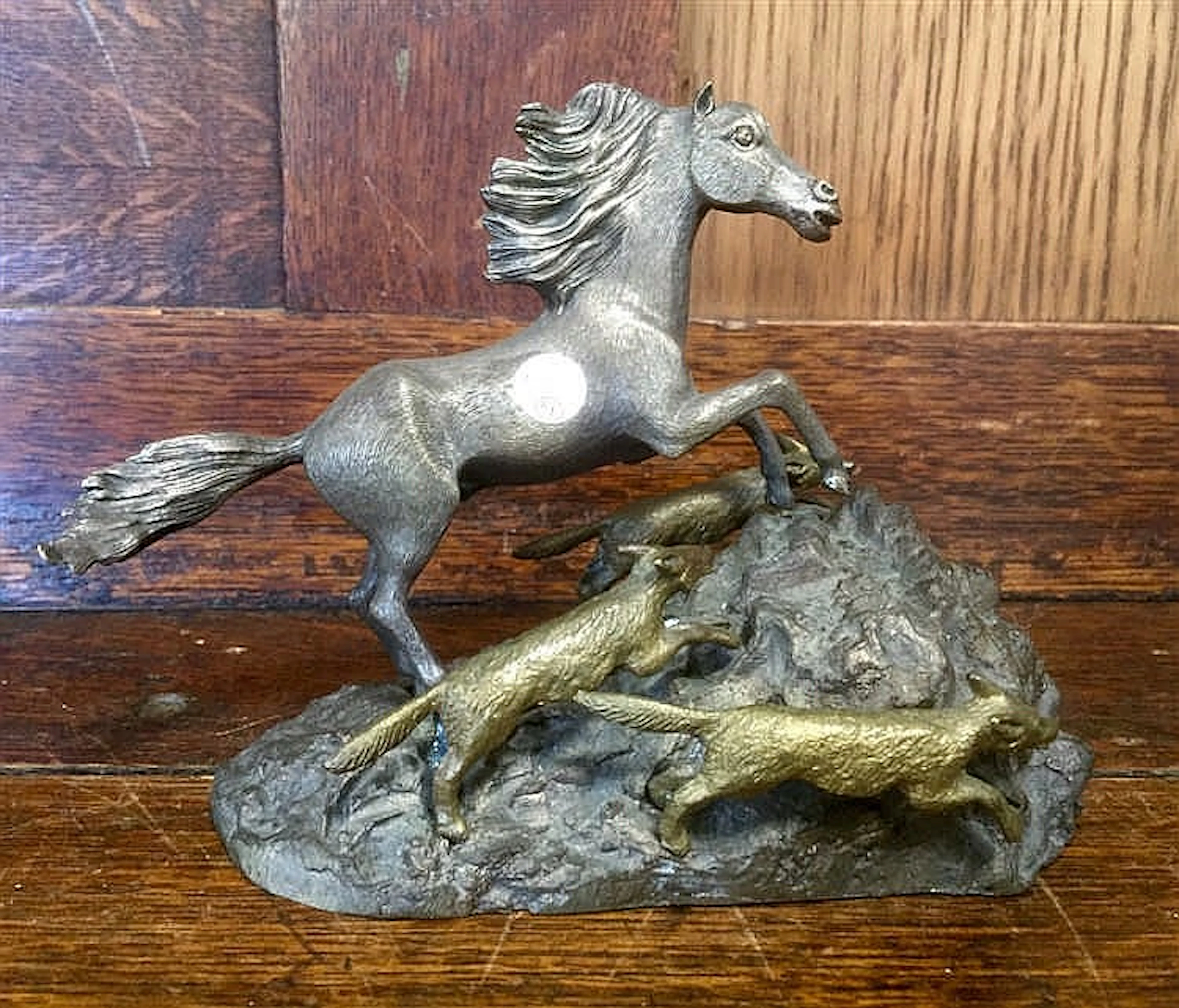 Bronze figure of a rearing horse with three foxes running by its side