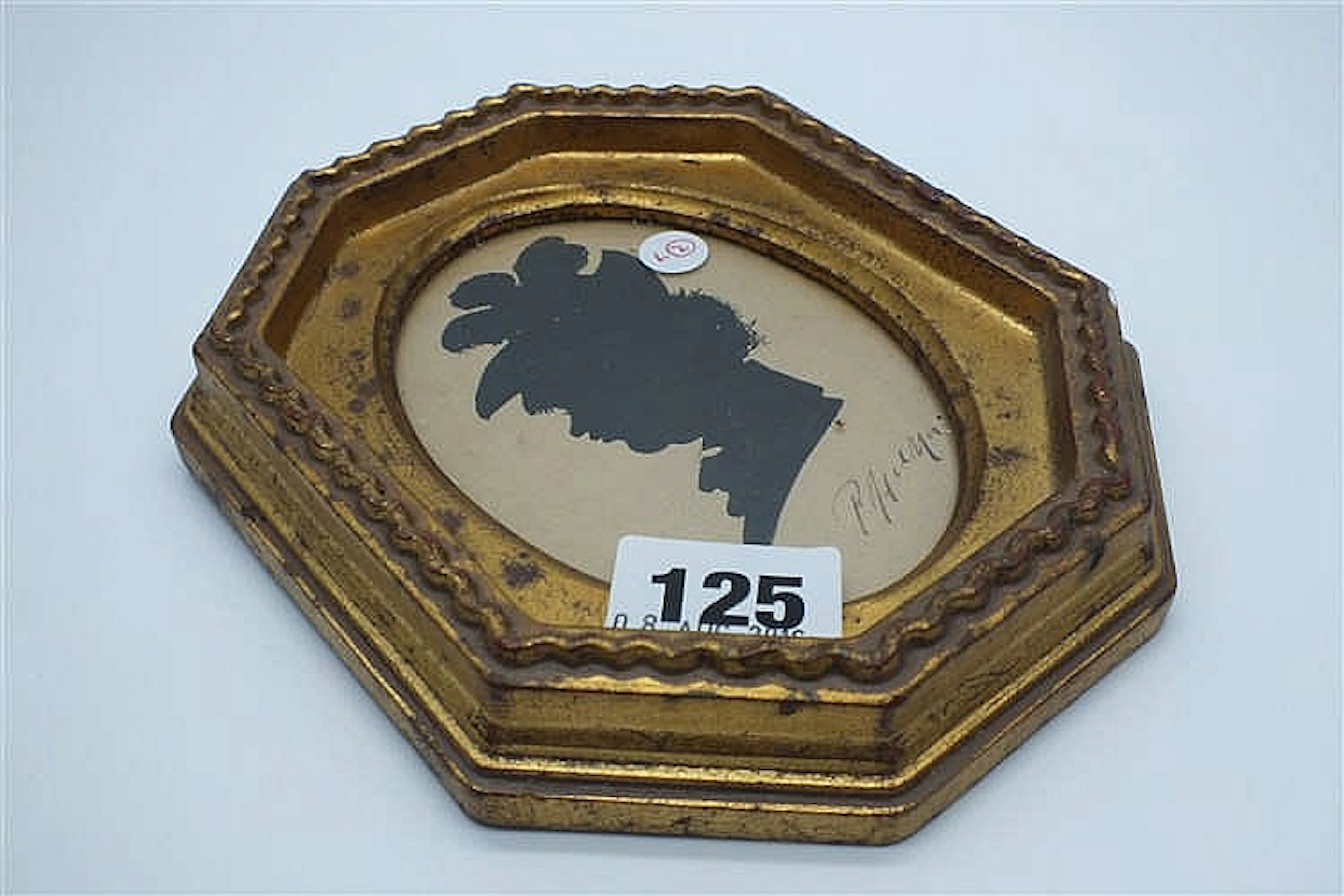 Silhouette of lady in profile in octagonal frame