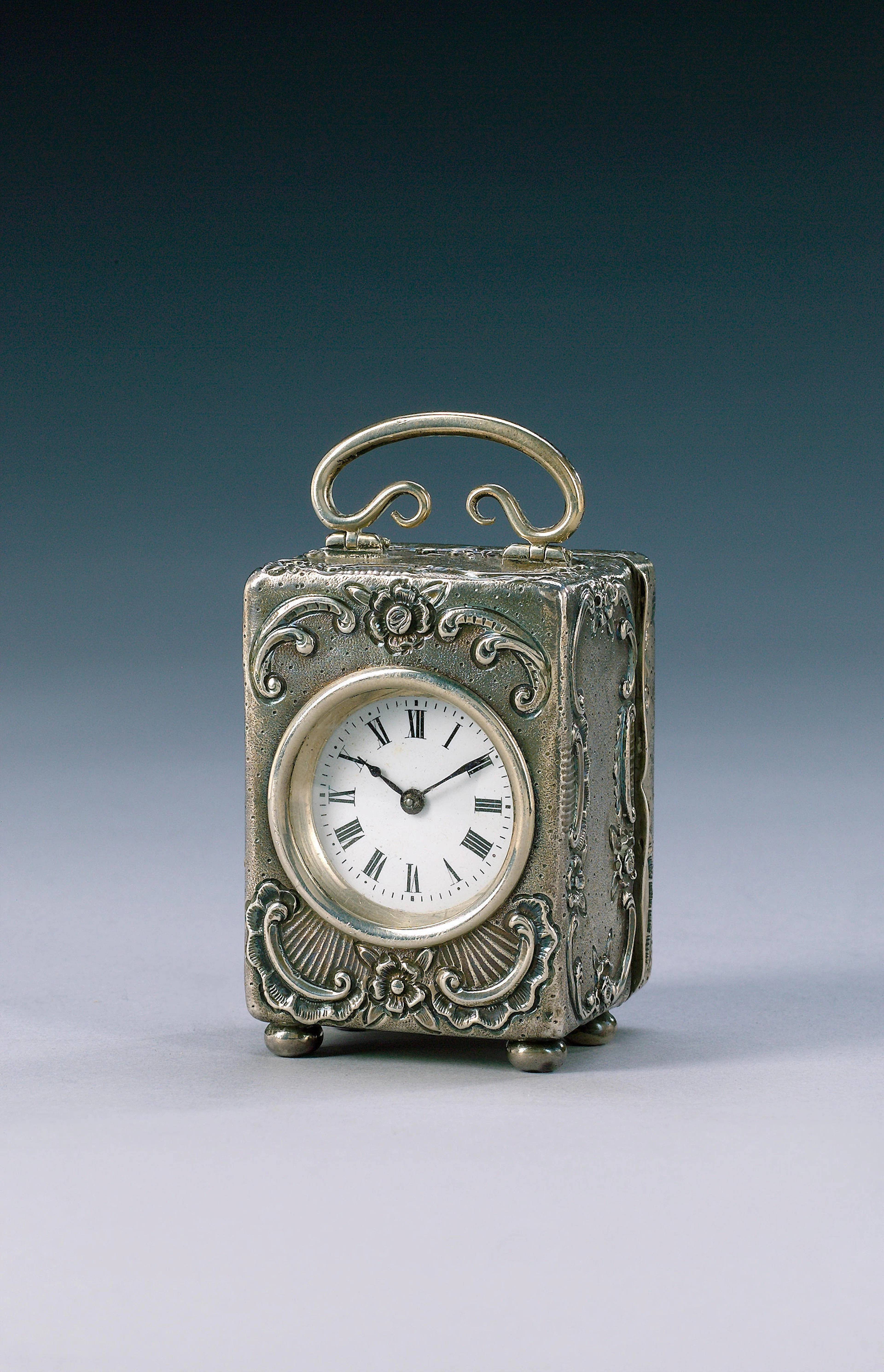 An early 20th century silver cased roccoco revival boudoir timepiece hallmarked for WN/GN, London 1905
