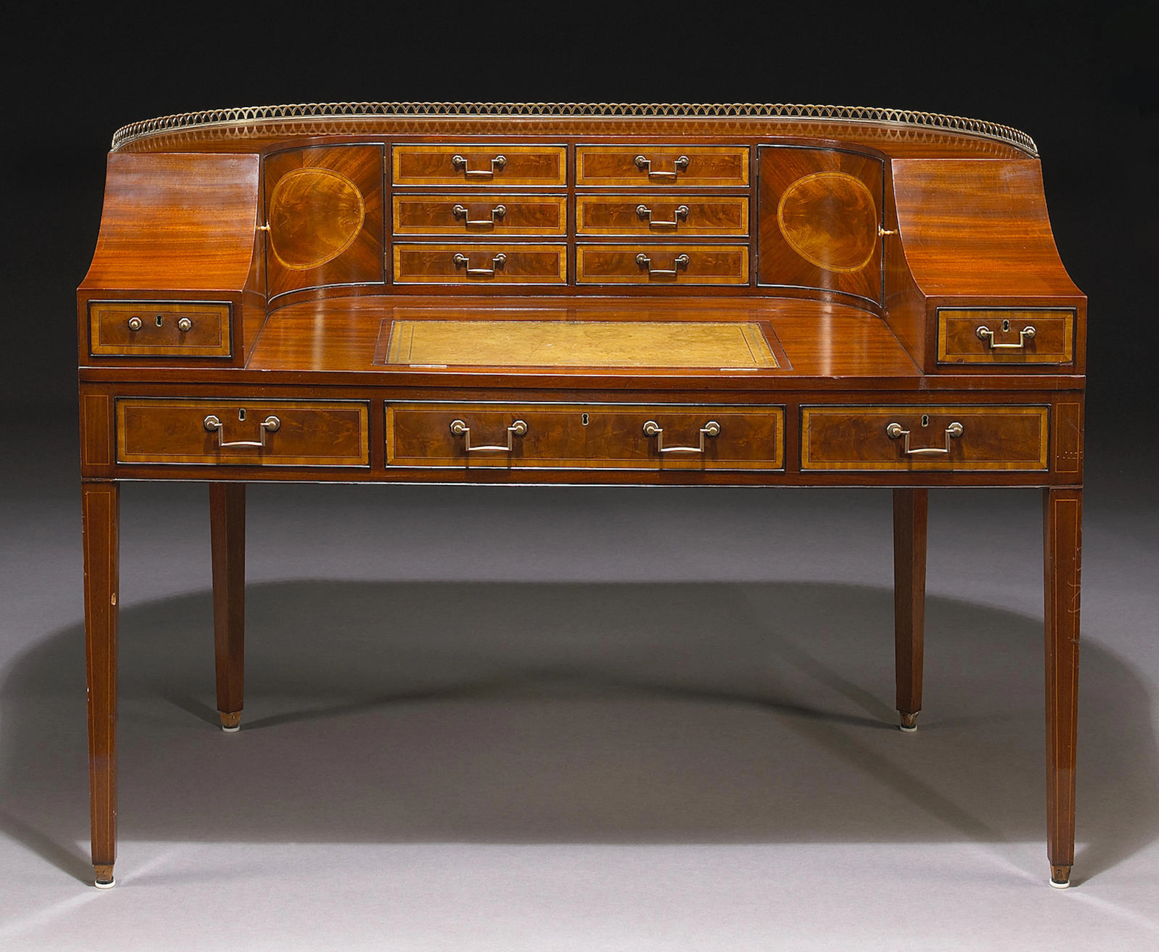 A George III style inlaid mahogany desk of Carlton House form