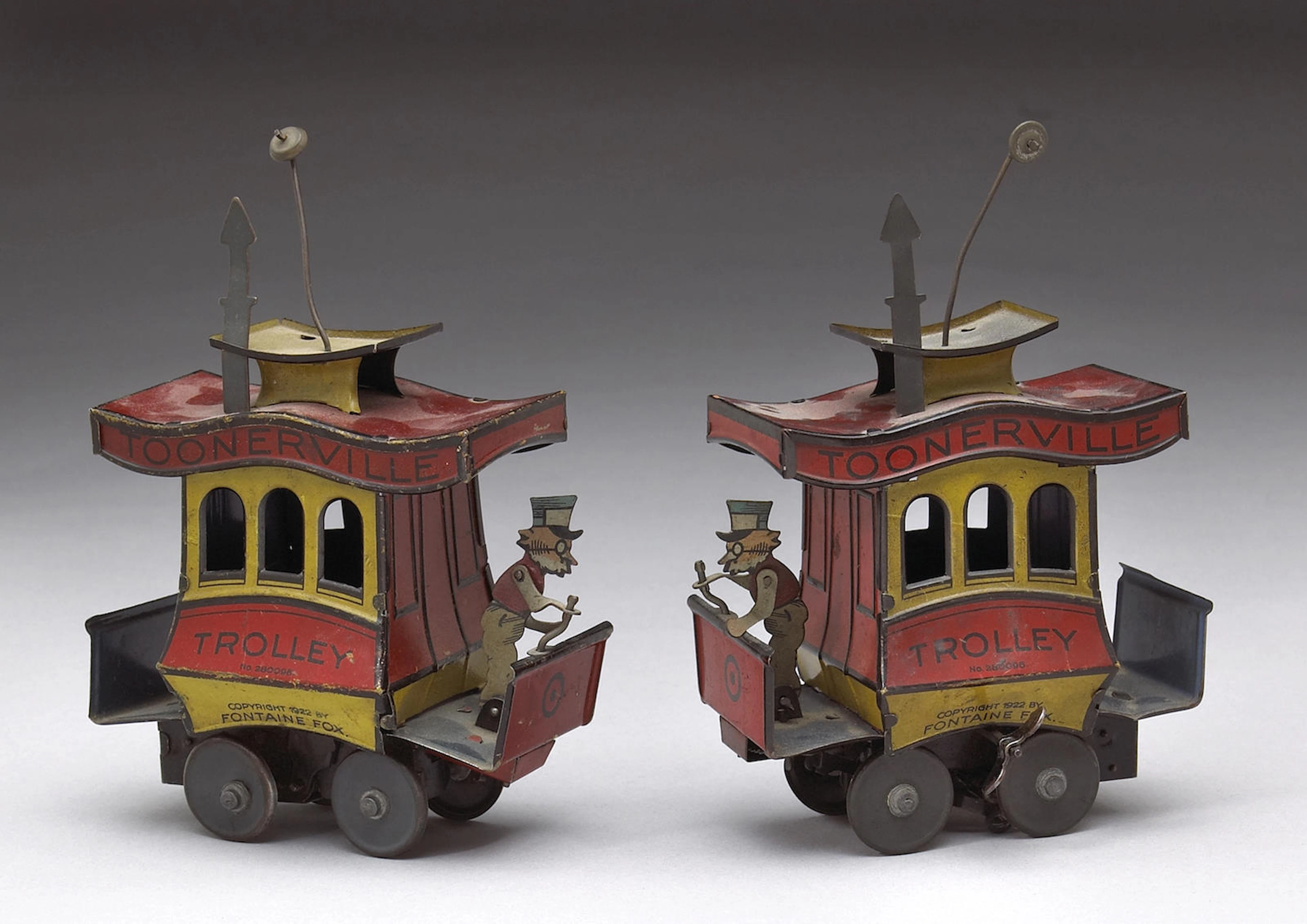 A pair of Toonerville Trolley tin wind-up toys Height: 7½in