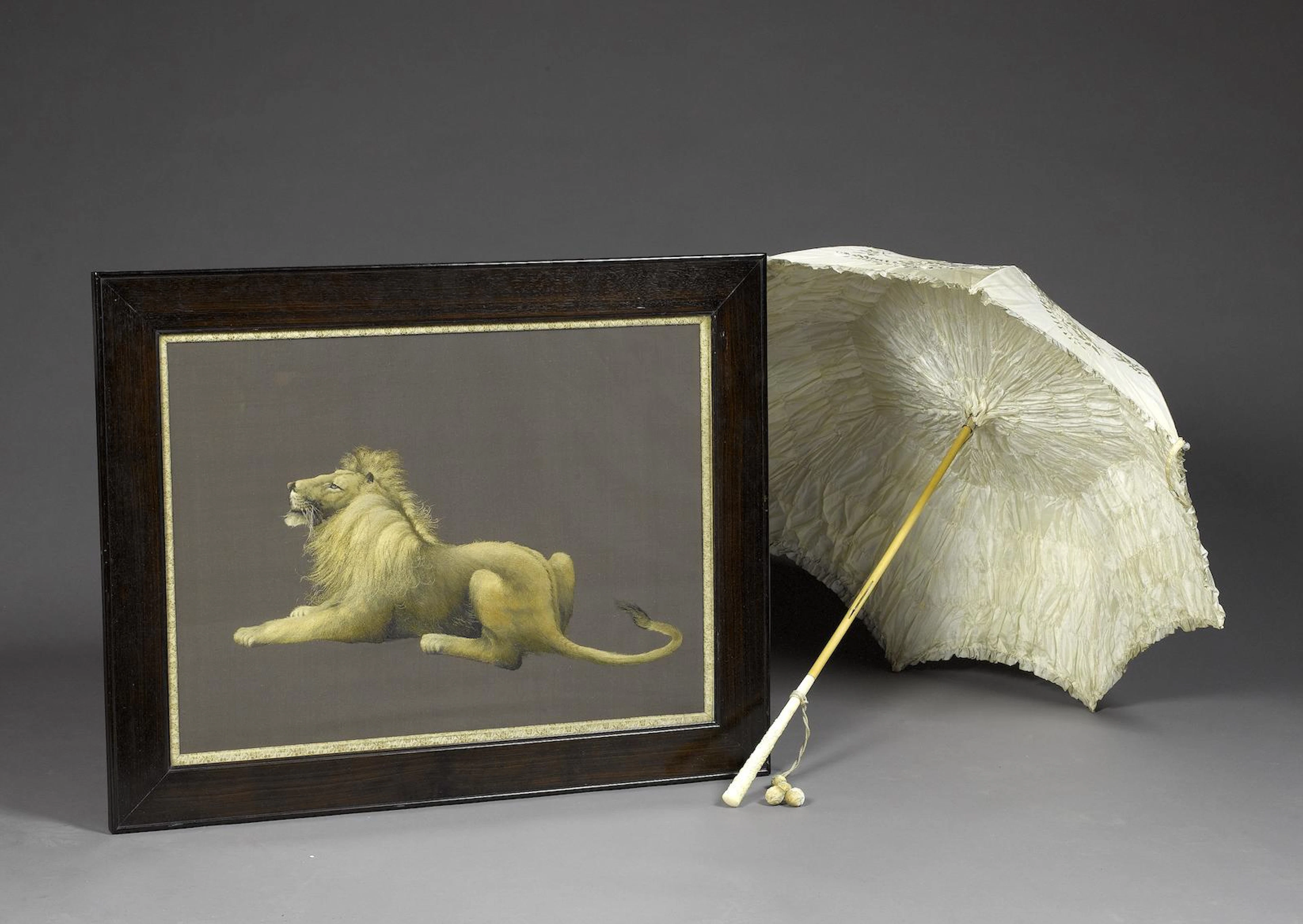 A silk-embroidered panel and a parasol Circa 1900