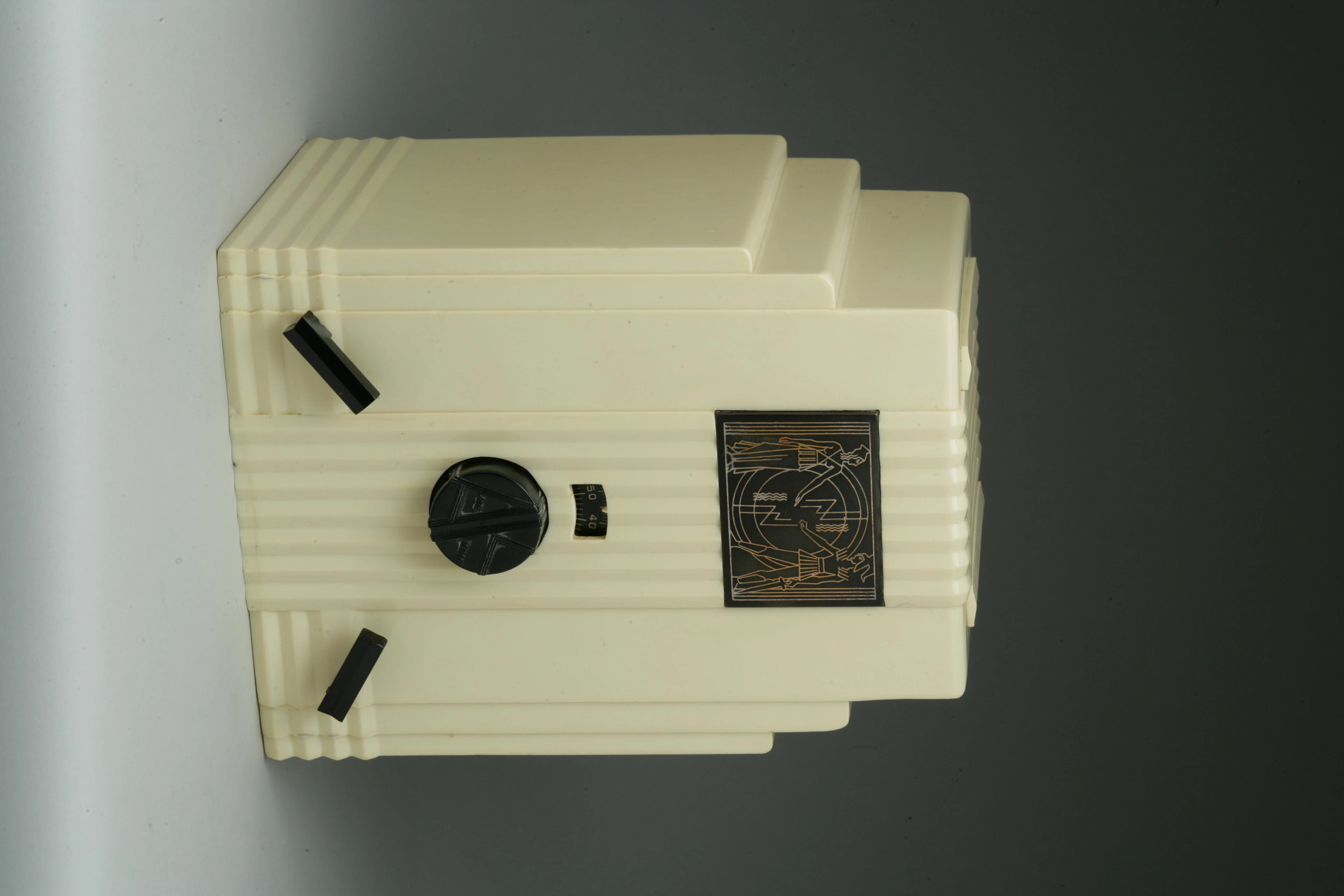 Air King 52 1933 White case with black lever knobs and an Egyptian dial. Height 11 3/4in; width 8 3/4in; depth 6 3/4in.