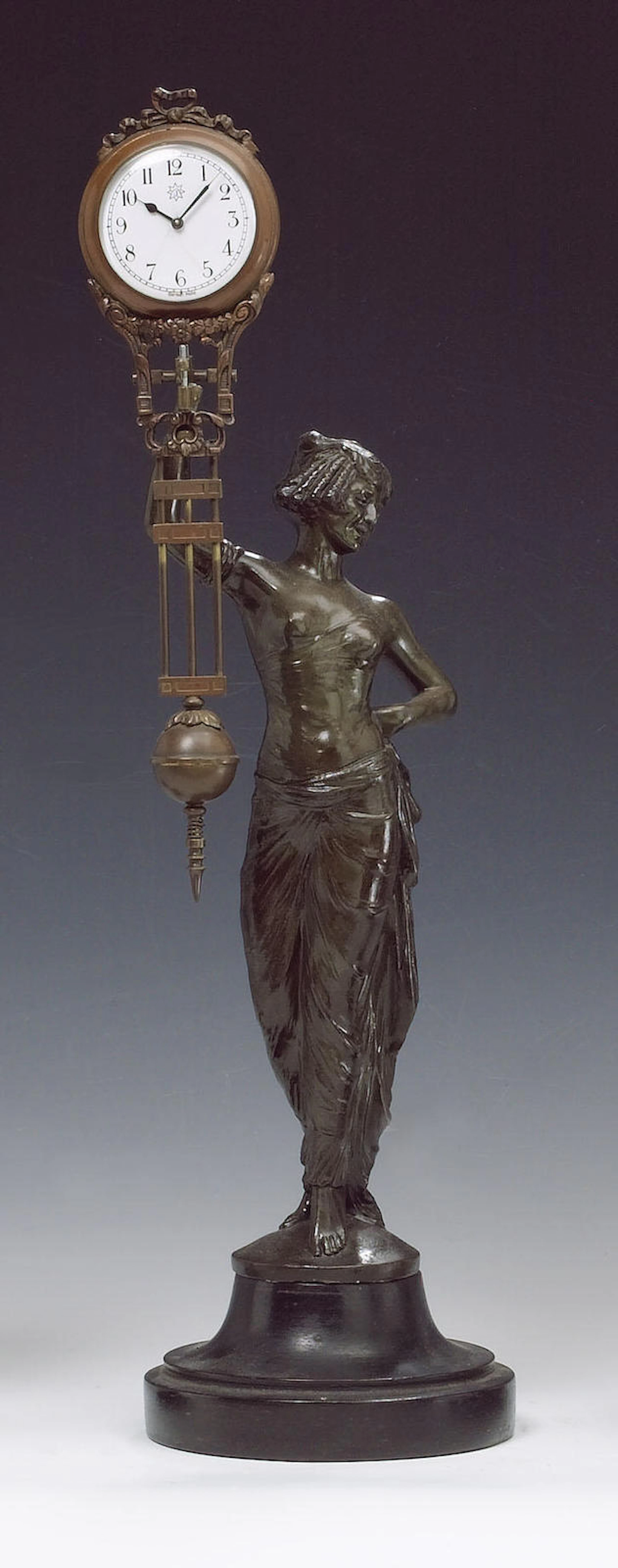 An unusual swinging mystery clock depicting a spelter lady, Junghans, Germany,