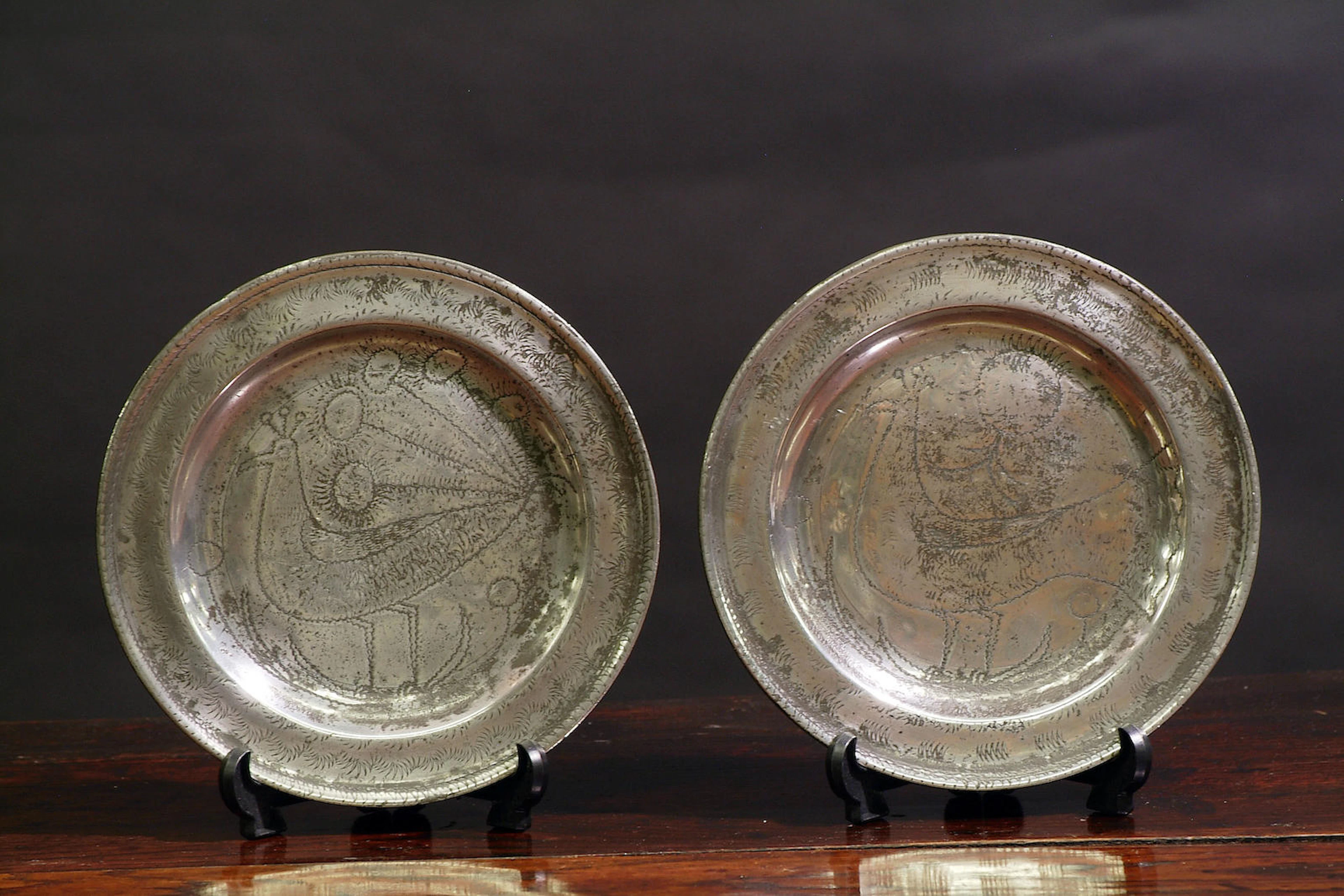 A fine pair of wrigglework marriage plates, circa 1720